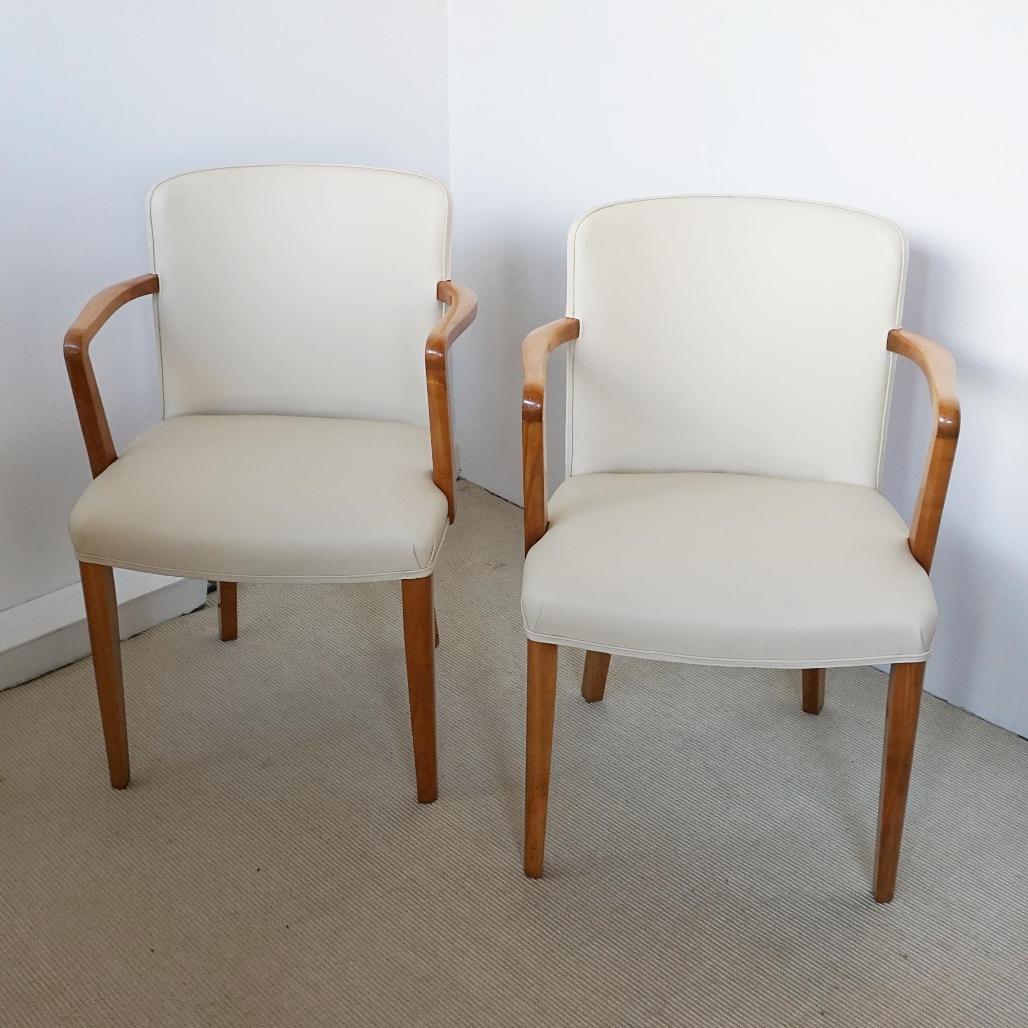 A pair of Art Deco armchairs by Heal's of London. Satinwood veneered with solid satinwood legs and arms. Re-upholstered in cream leather. 

Dimensions: H 84cm W 58cm D 48cm Seat H 48cm W 48cm D 40cm

