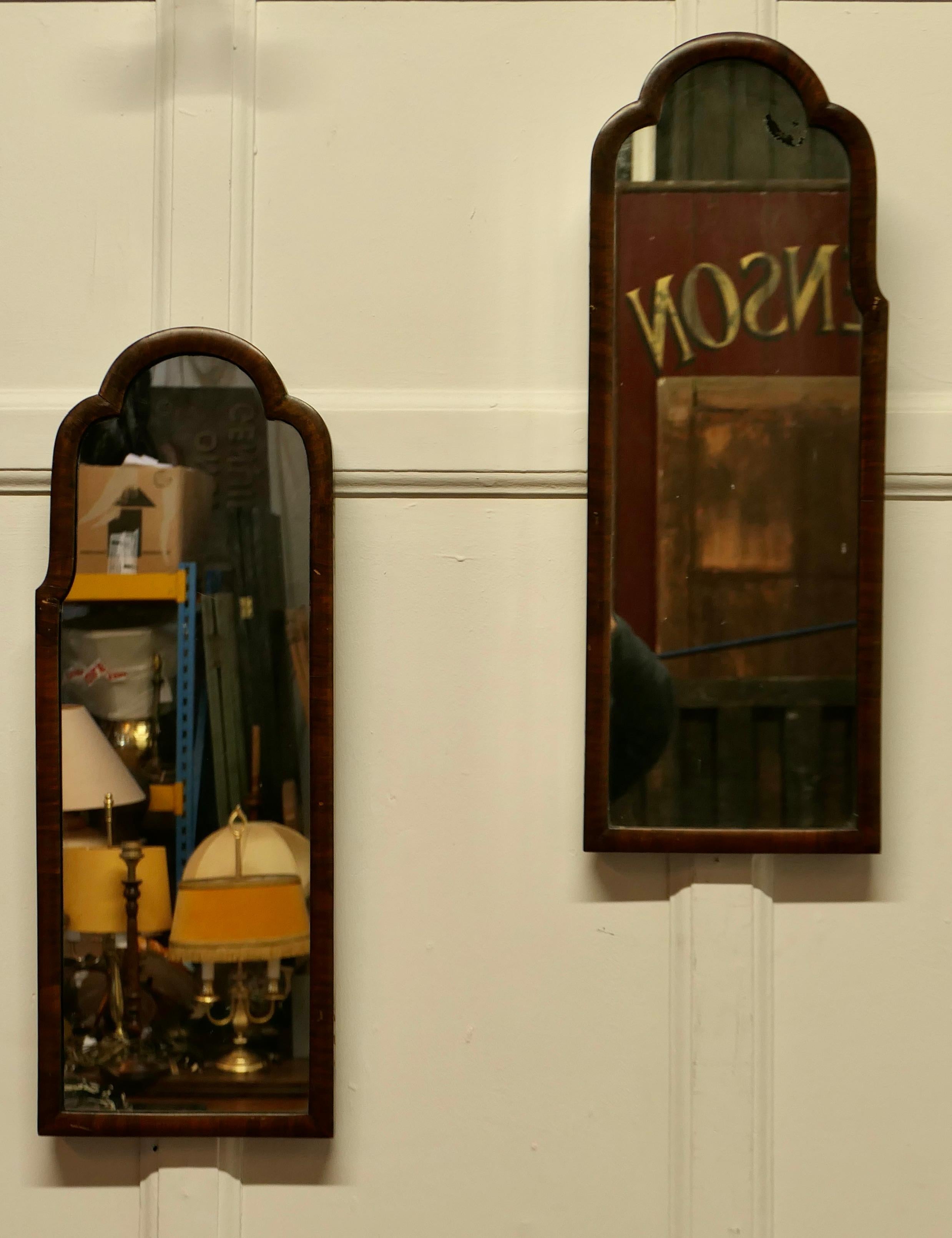A Pair of Art Deco Asymmetric Walnut Mirrors

A Quirky pair, the mirrors have an inch wide Walnut frame they are long and thin and are wall hanging The mirrors are in mostly good condition with a bit of foxing to the top arch of one
The mirrors are