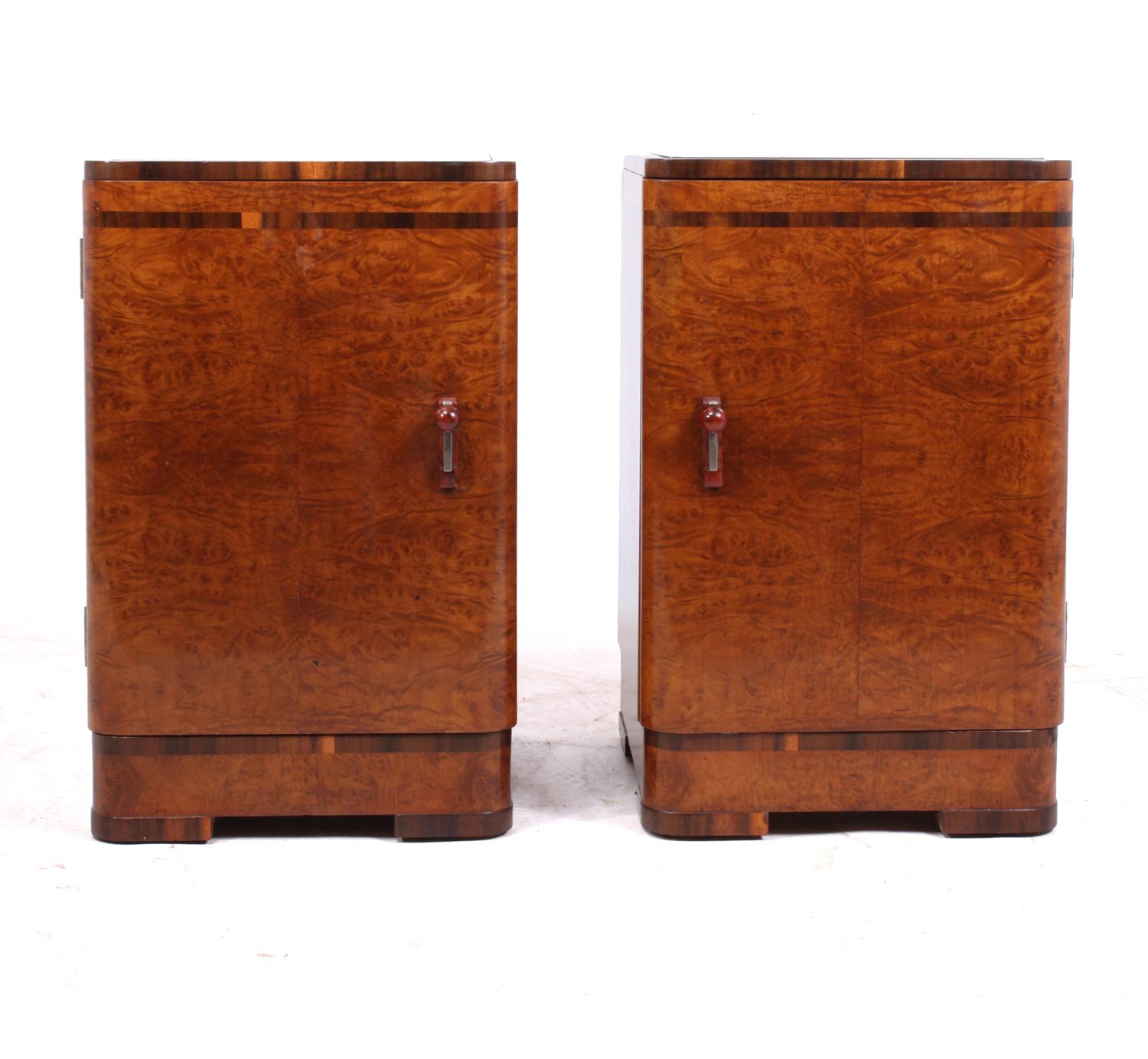 A pair of Art Deco bedside cabinets in burr maple.
A lovely pair of English original 1930s Art Deco bedside cabinets in burr maple with walnut cross-banding, they have black glass mirror tops and decorative bake-lite handles, one cabinet has a