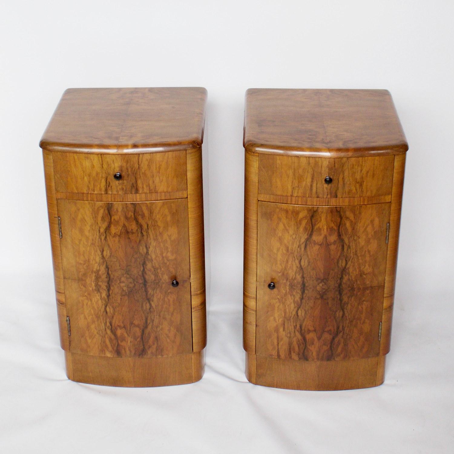 A pair of Art Deco bedside cabinets. Walnut veneered with round black bakelite handles. Integral double shelved cupboard with single drawer above. 

Dimensions: H 65cm W 37cm D 40cm 

Origin: English

Date: circa 1930

Item number: