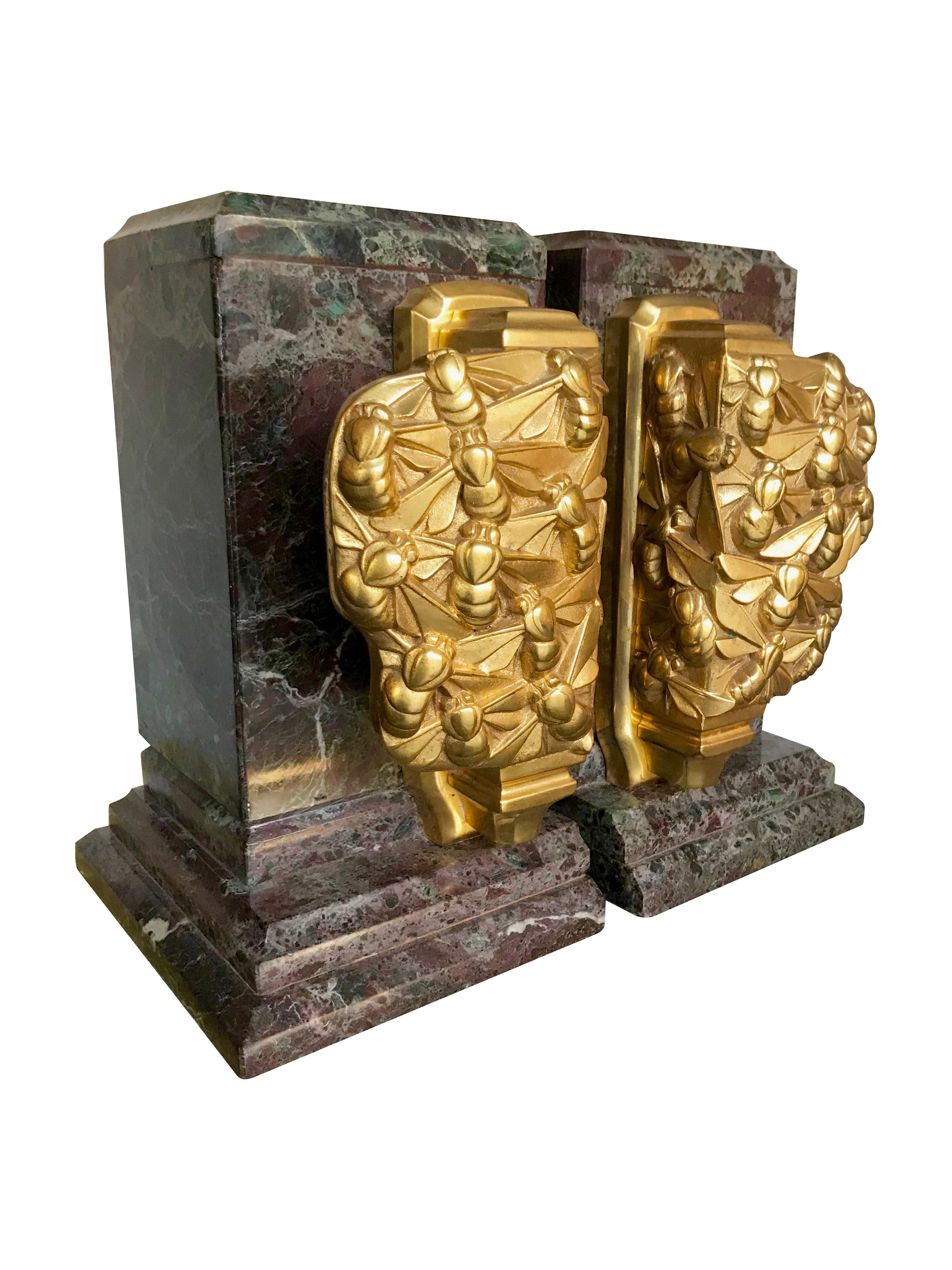 A fantastic pair of Art Deco bookends each with a swarm of gilt metal bees mounted on stunning green and purple amazonite marble.