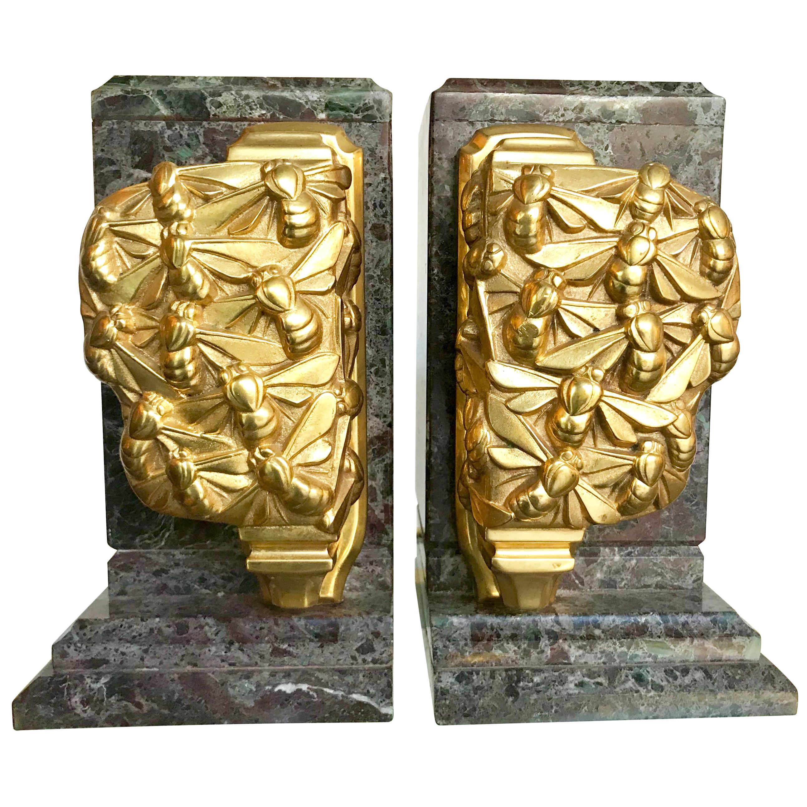 A pair of Art Deco bookends of amazonite marble and cast gilt metal bees