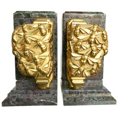 A pair of Art Deco bookends of amazonite marble and cast gilt metal bees