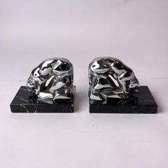 A pair of Art Deco bookends with drinking jaguars.