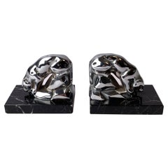 A pair of Art Deco bookends with drinking jaguars.