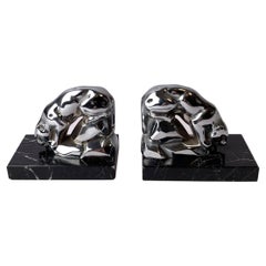 A pair of Art Deco bookends with drinking jaguars.