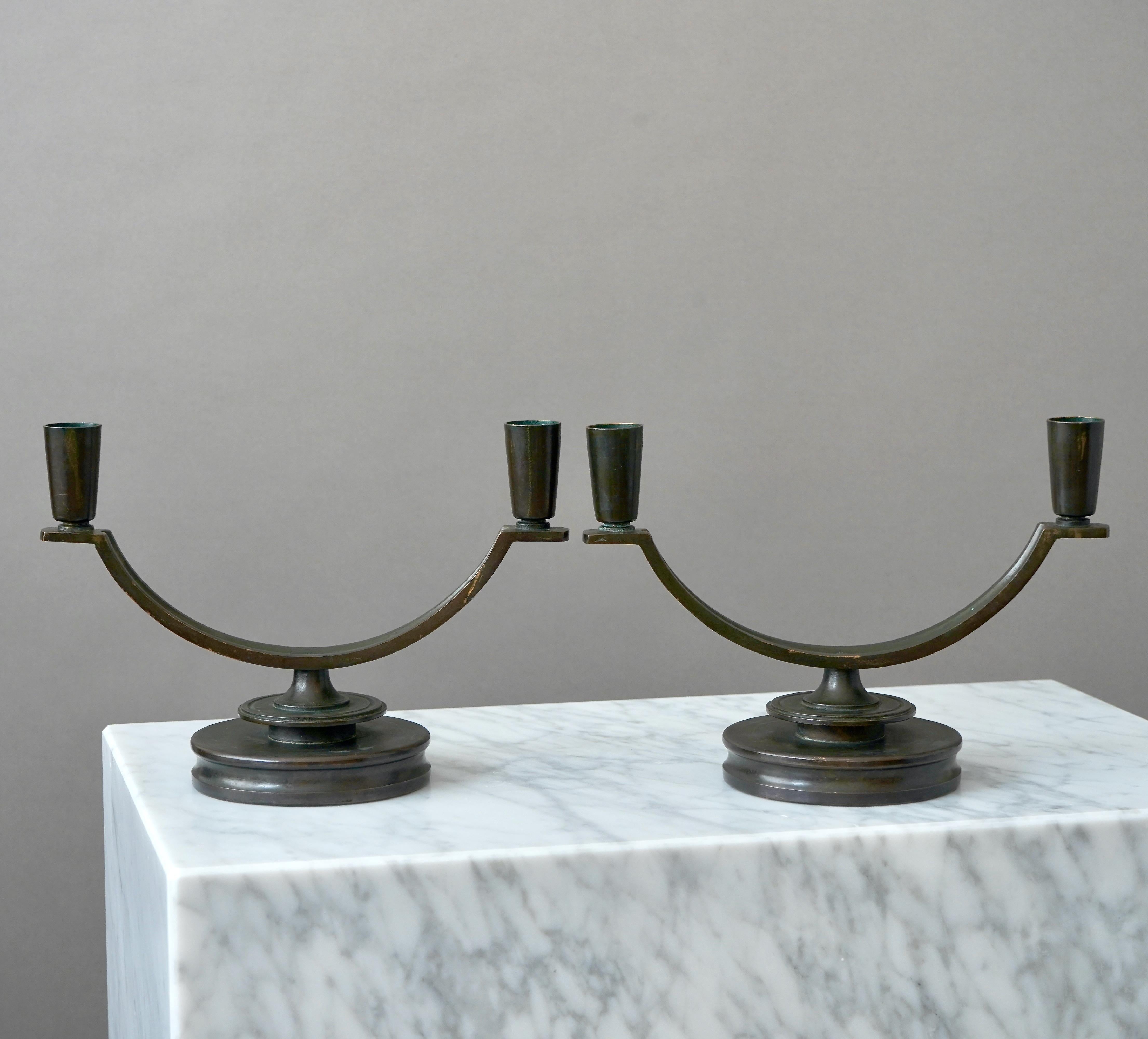 A pair of bronze Art Deco / Swedish Grace candelabras with amazing patina. 
Made by Nordiska Juvelaktiebolaget, Sweden, 1930s.  

Good condition, some light scratches and wear to the patina.
Stamped 'ÄKTA BRONS' and makers mark.