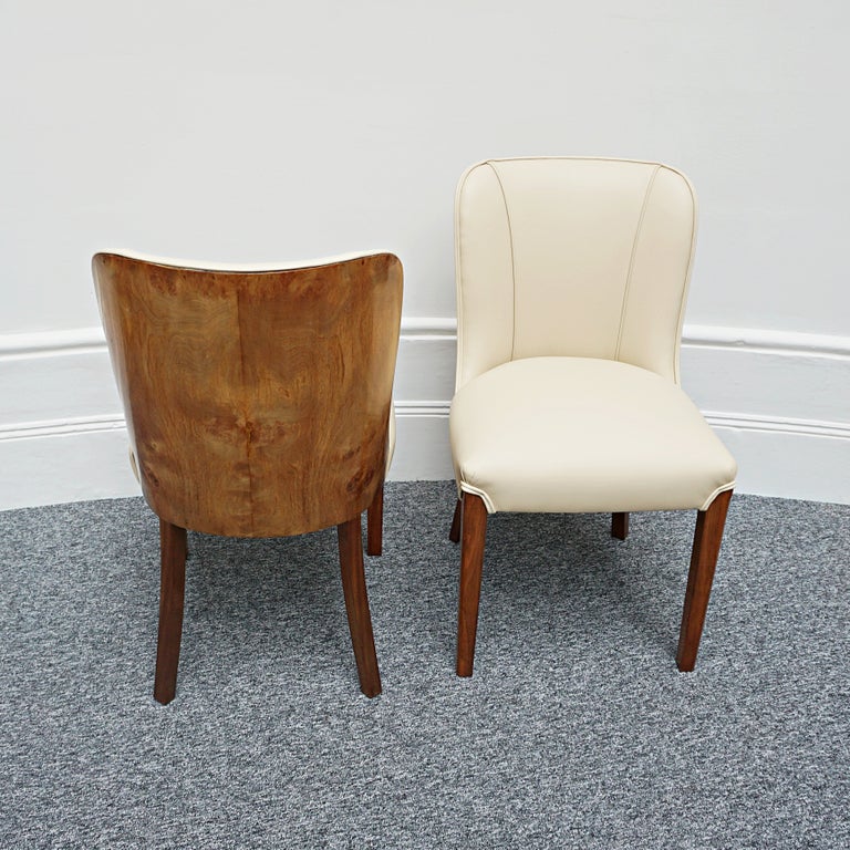 An Art Deco pair of side chairs. Burr walnut veneered backs with tapered solid walnut legs. Re-upholstered in cream leather. 

Dimensions: H 88cm, W 49cm, D 49cm, Seat H 47cm .

Origin: English

Date: Circa 1930

Item Number: 0108222

All