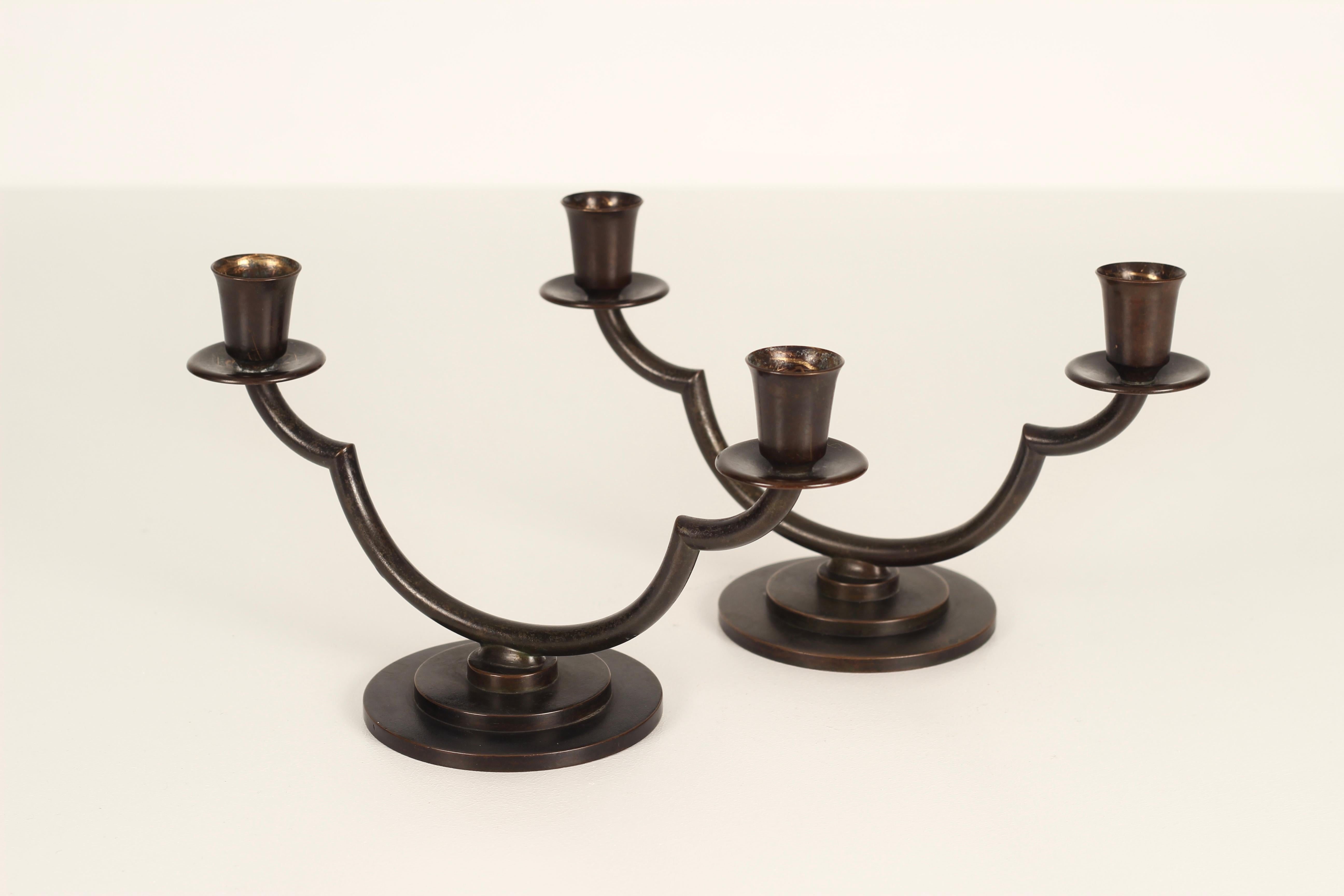 A pair of Art Deco candlesticks 1930s designed by Danish artist Just Andersen (1884-1943) The candlesticks have model no. LB 1476 and are made of Just Andersen´s own disco metal with brown patina.

Signed with monogram for Just Andersen and no LB