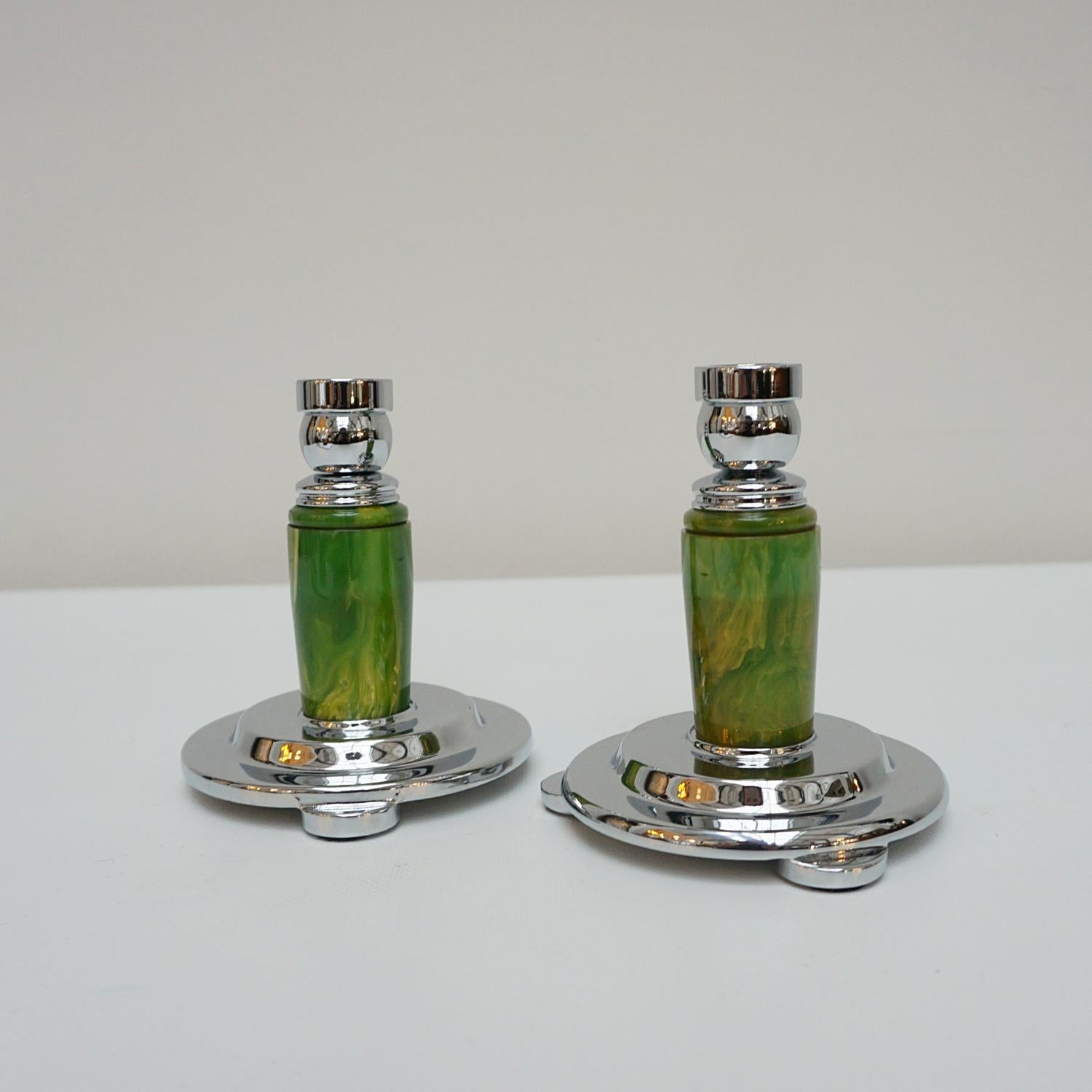 A pair of Art Deco candlesticks. Marbled greed rounded bakelite stem. Set over a rounded, stepped chromed metal base with chromed metal top. 

Dimensions: H 13cm W 11.5cm

Origin: English

Date: Circa 1935

Item Number: 2710233

Re-chromed and