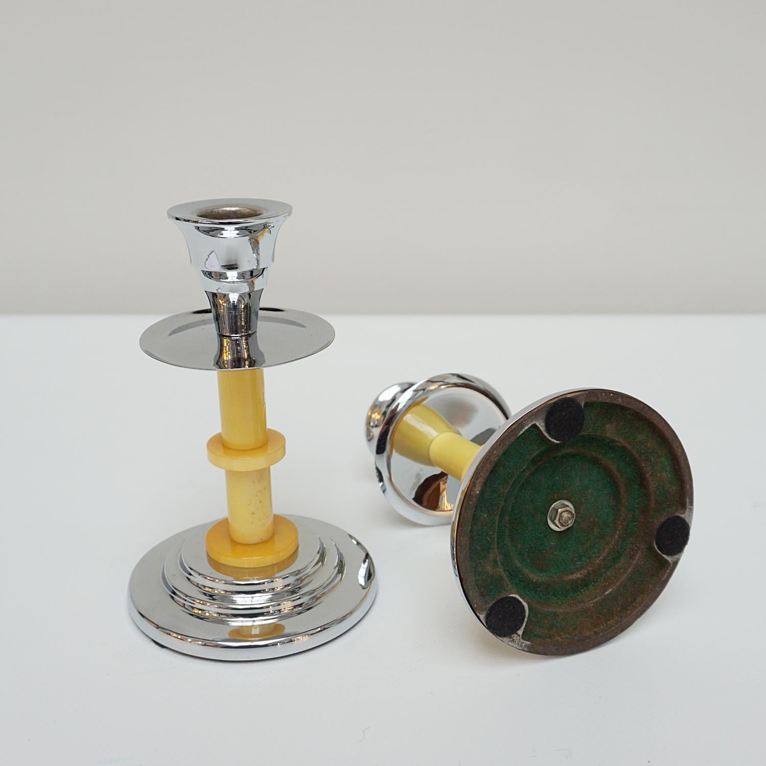 A pair of Art Deco candlesticks. Yellow dual ringed bakelite stem. Set over a rounded, stepped chromed metal base with chromed metal top. 

Dimensions: H 16cm W 10cm

Origin: English

Date: Circa 1935

Item Number: 2710234

Re-chromed and polished