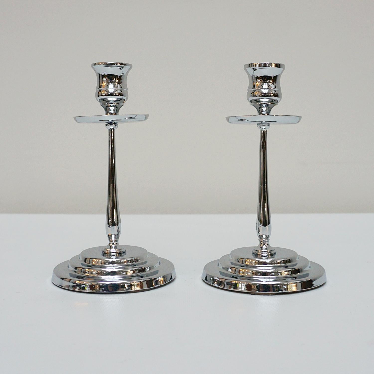 A pair of Art Deco candlesticks. A chromed slender stem. Set over a rounded with stepped chromed metal base with chromed metal top. 

Dimensions: H 18cm W 10cm

Origin: English

Date: Circa 1935

Item Number: 2710236

Re-chromed and polished with