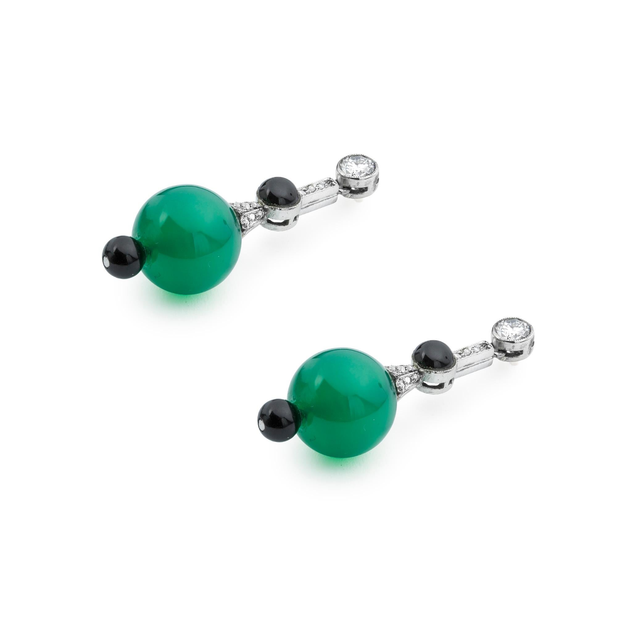 A pair of Art Deco chrysoprase, onyx and diamond drop earrings, each earring comprising a round brilliant-cut diamond on top, estimated to weigh 0.20ct each, suspending a rose-cut diamond and onyx set run, suspending a chrysoprase bead, measuring