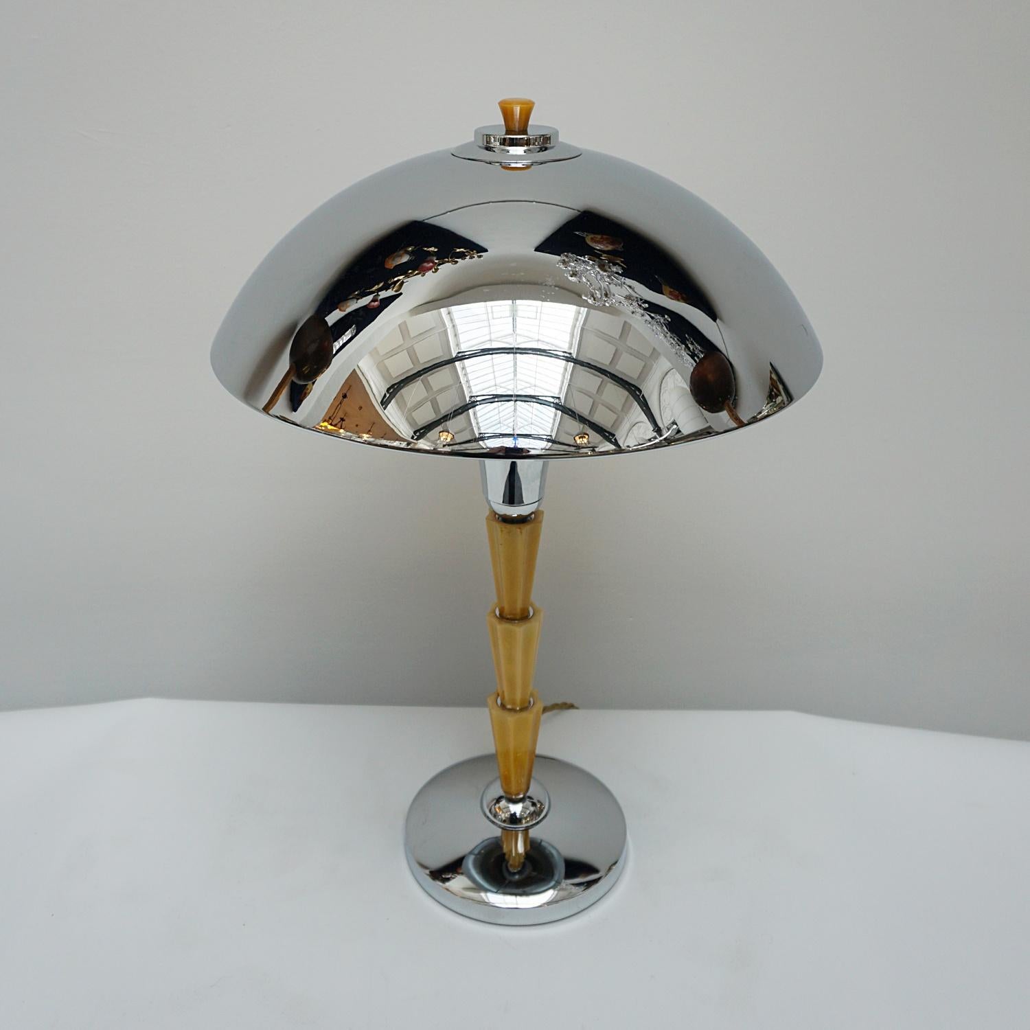 A pair of Art Deco style dome lamps. Three pieces of fluted marble yellow bakelite, set over a chromed metal base. Yellow finial topped chromed metal shade. 

Dimensions: H 53cm Diameter of shade: 37cm, of base: 17.5cm

All of our lighting is