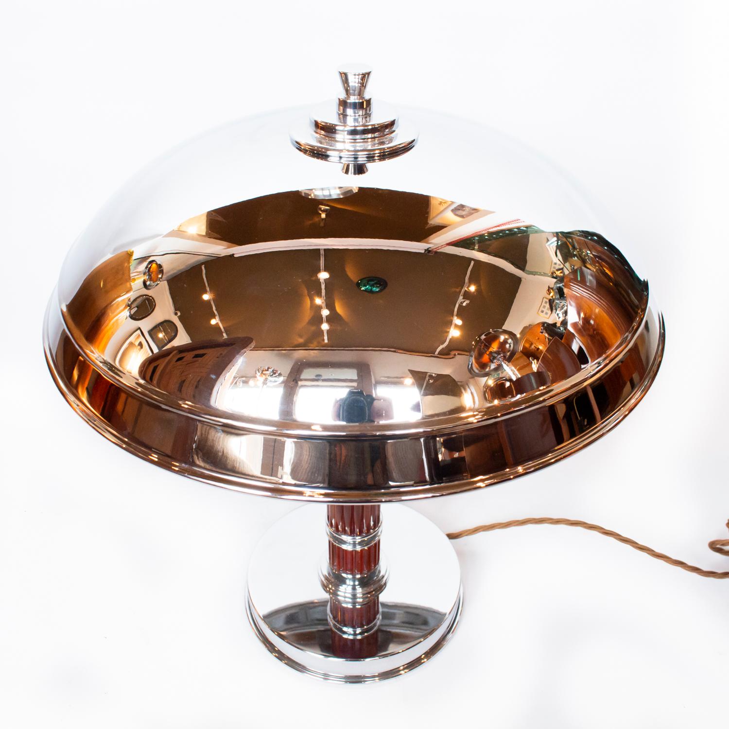 A pair of Art Deco dome lamps with chrome domed shades. Straight amber bakelite and chrome stem with a chromed metal base. Chromed finial to top.

Dimensions: H 41 cm, W of shade 33 cm, W of base 16 cm

Origin: English

Date: circa