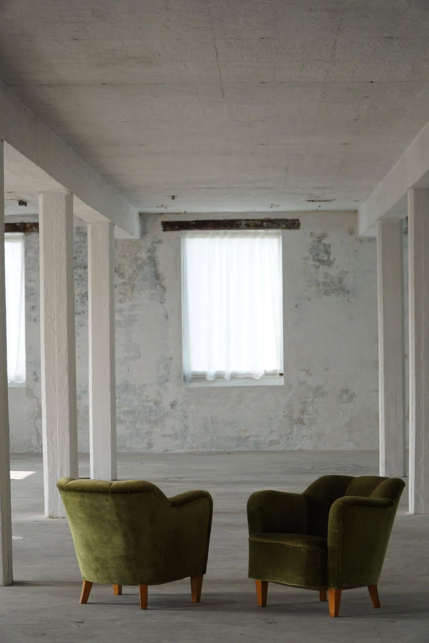 This pair of lounge chairs in green velour showcases the remarkable craftsmanship of a Swedish cabinetmaker during the Art Deco period in the 1940s. These chairs have an air of elegance and sophistication about them, combining the luxurious appeal