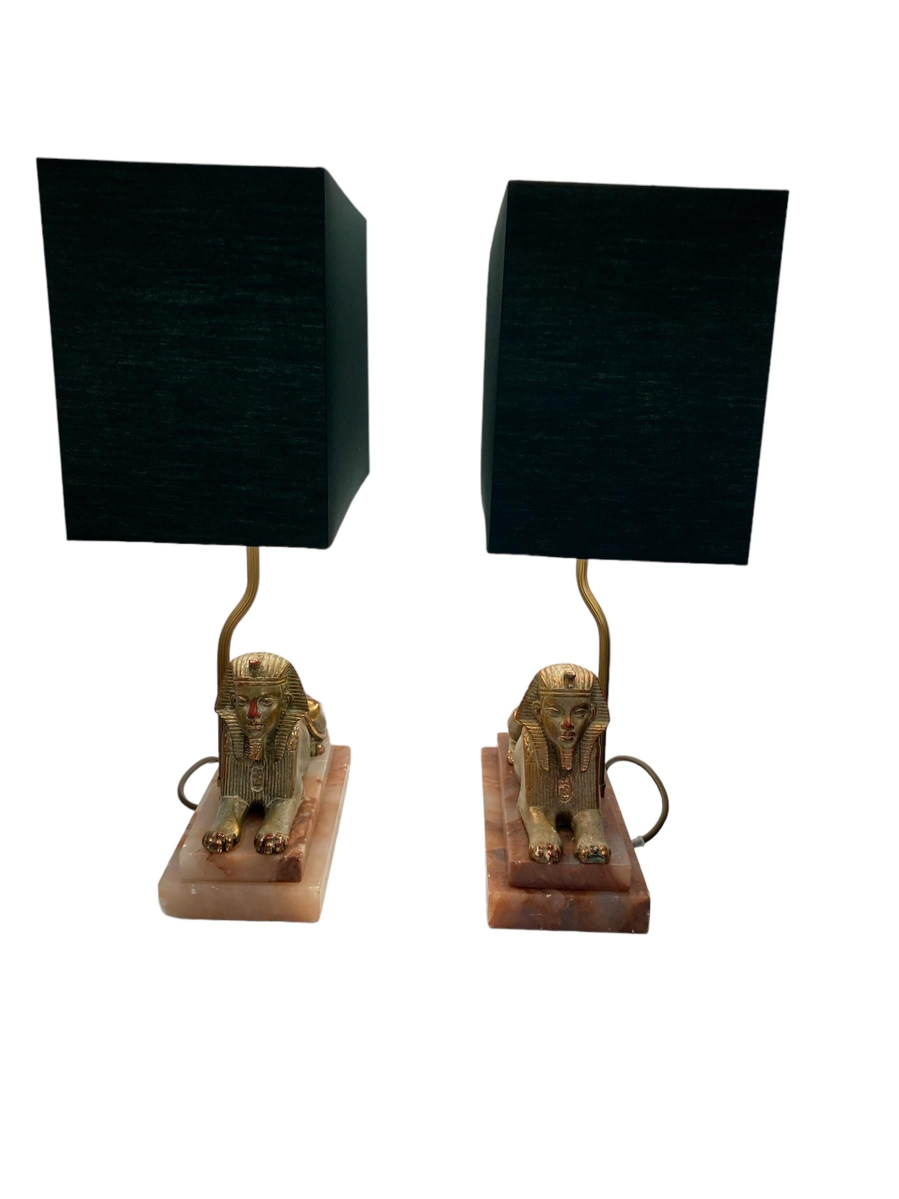 Spelter A Pair of Art Deco Egytian Sphinx Table Lamps on a Marble Base Dark Green Shades For Sale
