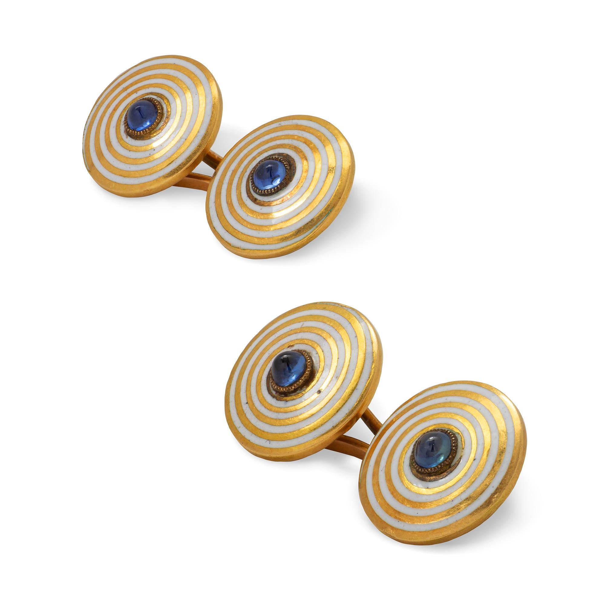 A pair of Art-Deco enamel and sapphire cufflinks, each link consisted of two round plaques with white enamelled spiral decoration, centrally-set with a cabochon sapphire, all in yellow gold mount with detachable figure-of-eight gold fitting, circa