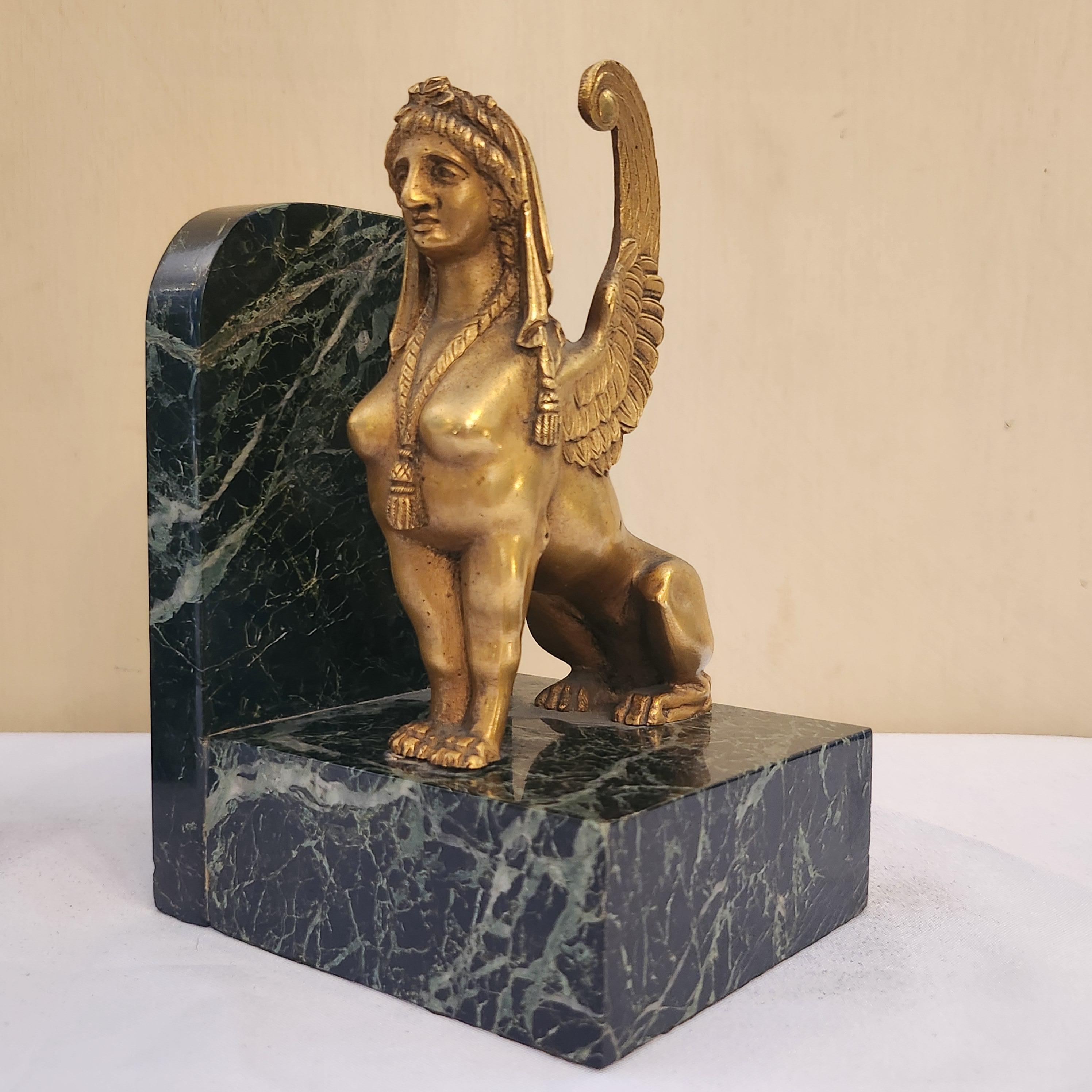 These art deco bronze gilt and marble base sphinxes bookends are a stunning example of the elegance and sophistication of the art deco era. Crafted with meticulous attention to detail, these bookends feature majestic sphinxes, mythical creatures