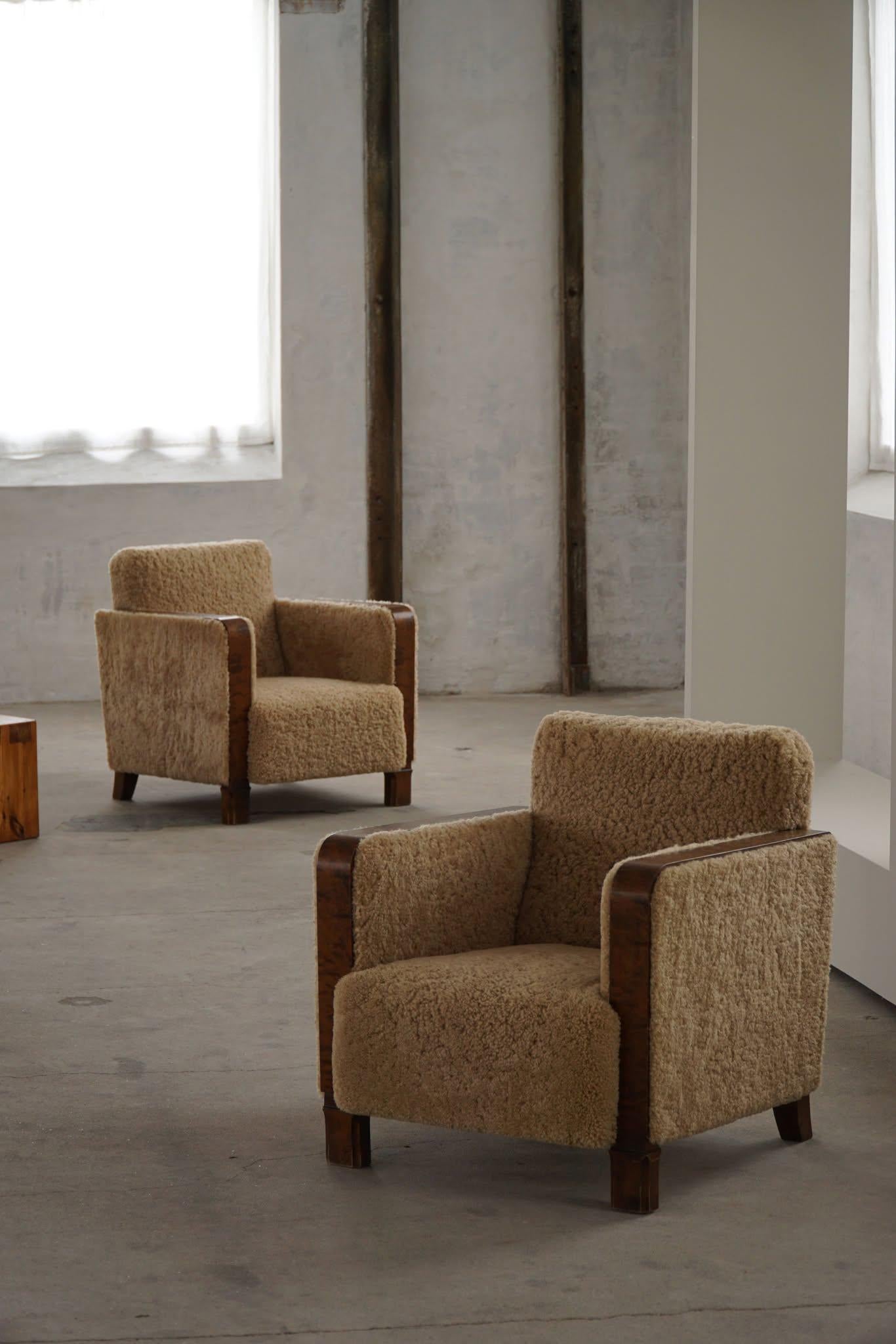 A striking pair of Swedish lounge chairs from the 1930s, exemplifying the refined elegance of the Swedish Grace movement. These chairs showcase a bold, cubistic silhouette characteristic of the Art Deco era, with clean, architectural lines and a