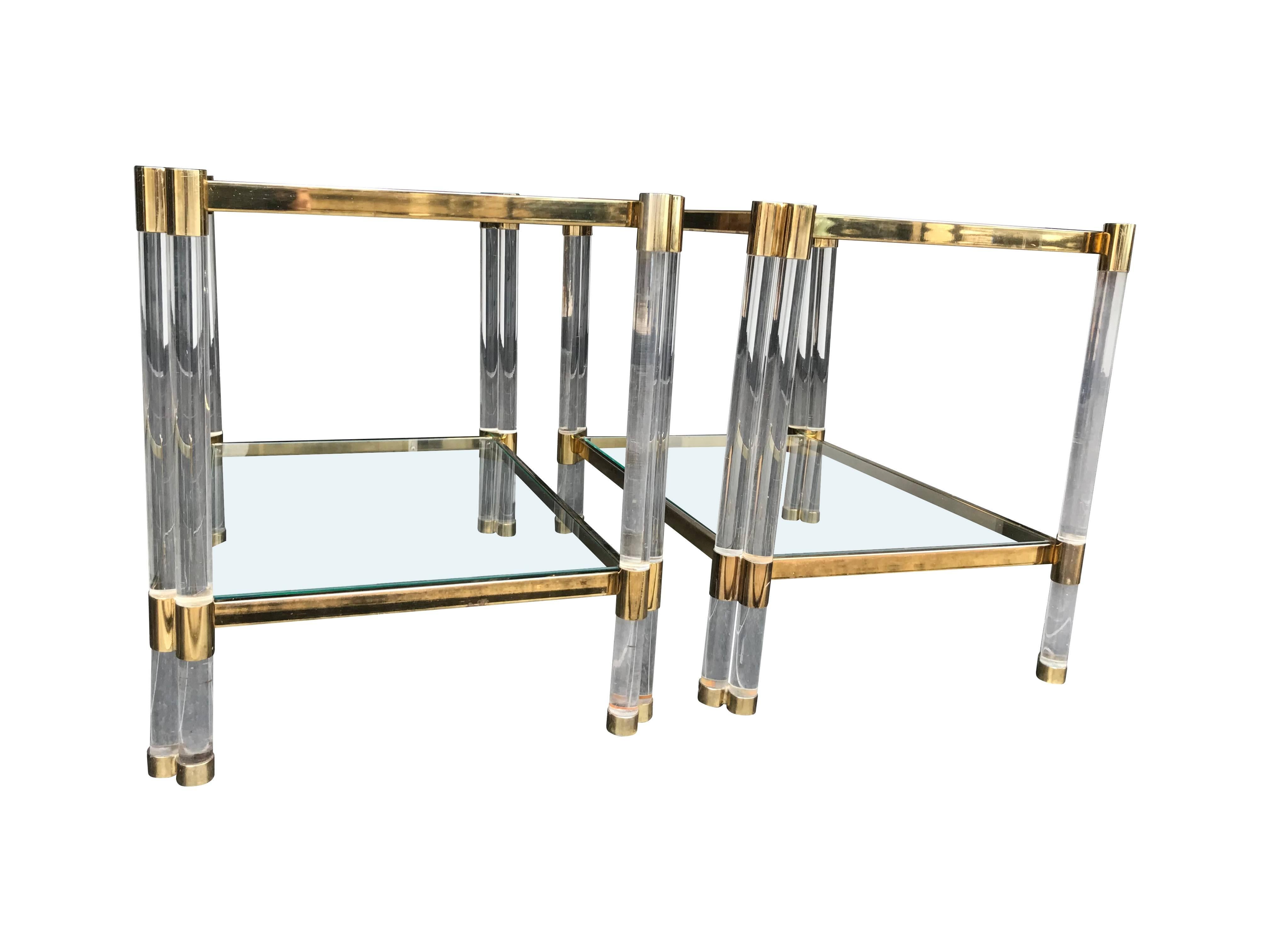 A pair of Art Deco style Lucite and gilt metal side tables, each with two tubes of Lucite on each leg, two glass shelves and gilt metal frame.