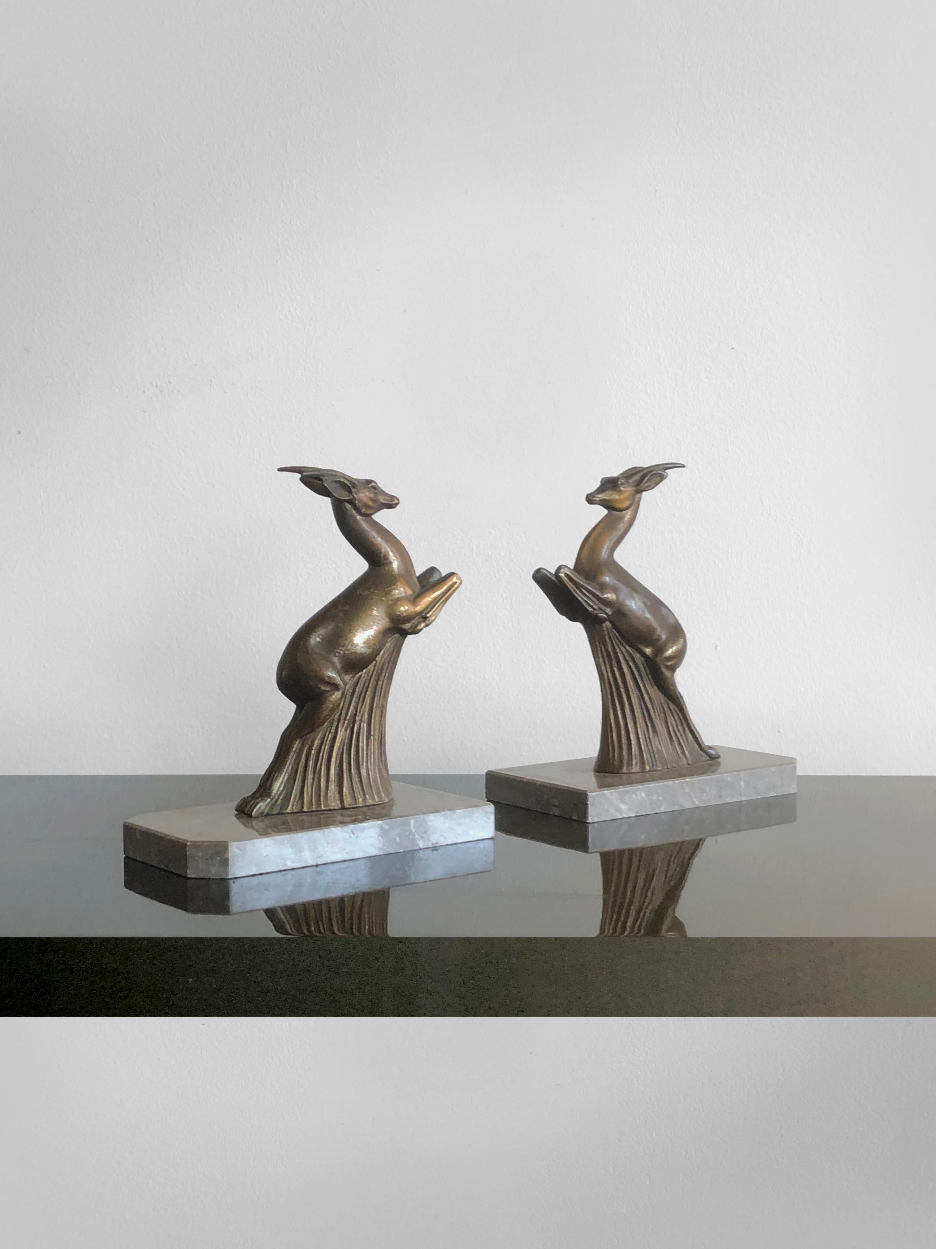 A beautiful and elegant pair of sculptural animalist bookends, France 1930.
Each piece represents a stylisezed jumping dear bronze sculpture on a massive grey marble base. The thin details of the sculptures and the dynamic movement of the dears are