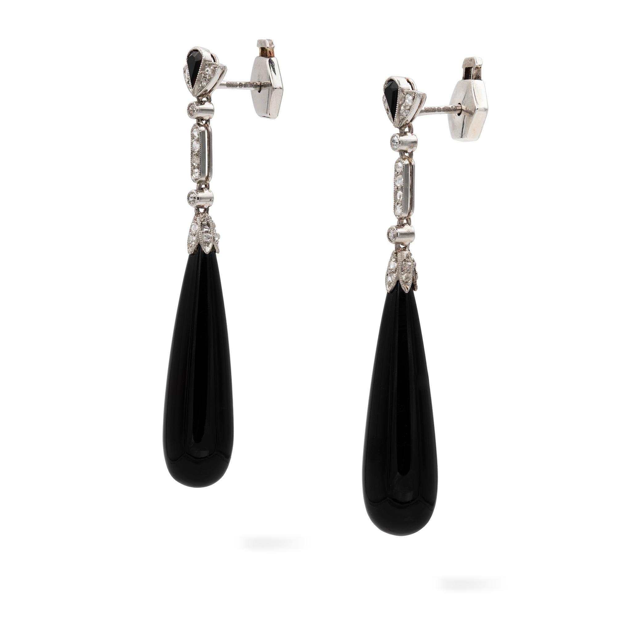 A pair of Art-Deco onyx and diamond drop earrings, each earring with a pear-shaped onyx with a rose-cut diamond set cap, suspended by a rose-cut diamond-set bar terminating to two single rose-cut diamond-set collets, to a fan-shaped top with a