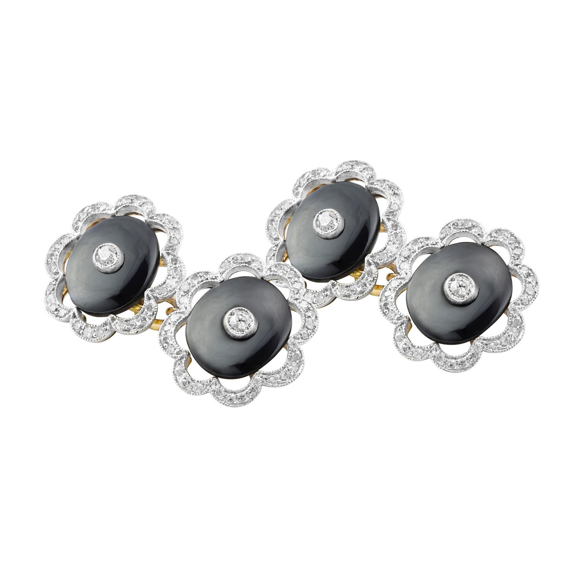 A pair of Art Deco onyx and diamond scalloped cufflinks, the oval onyx discs measuring approximately 10 x 8mm with a central old brilliant cut diamond in a millegrain setting, all surrounded by an openwork scalloped border millegrain set with