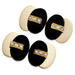 A pair of Art Deco onyx and pearl gold cufflinks