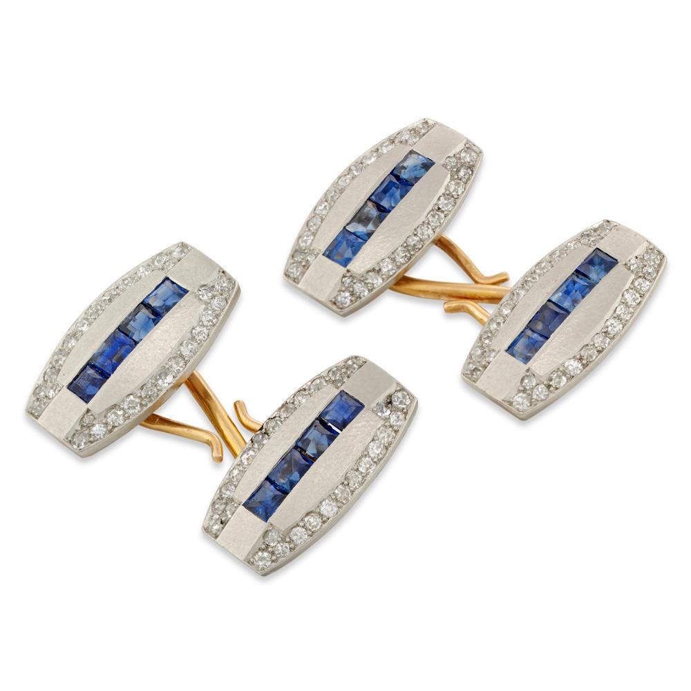 A pair of Art Deco sapphire and diamond cufflinks, each cufflink  consisting of two modified oval matt platinum plaques with straight sides, four square-cut sapphires channel-set in a line to the centre, estimated to weigh a total of 1.90 carats,