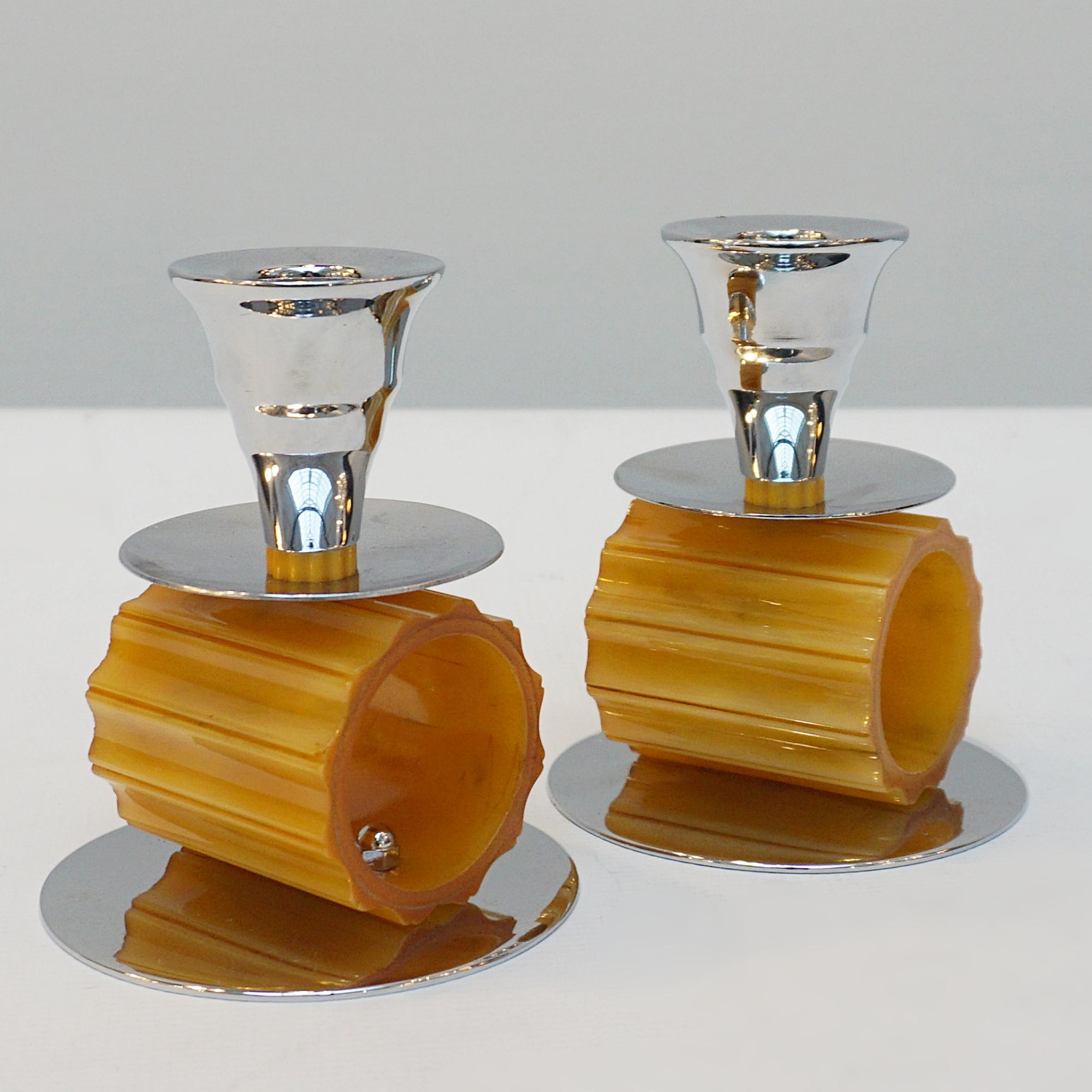 A pair of Art Deco style candlesticks. Amber bakelite cylindrical ridged stem. Set over a rounded chromed metal base.

Dimensions: H 11cm W 9cm

Origin: English

Item Number: 2212231

Re-chromed and polished with some replacement parts.