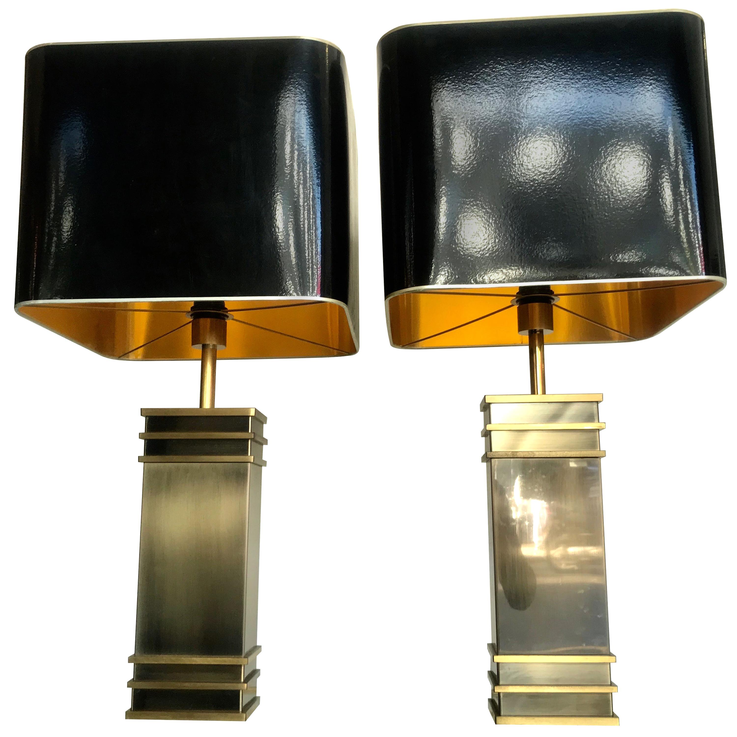 A pair of Art Deco style brass lamps with original shades 