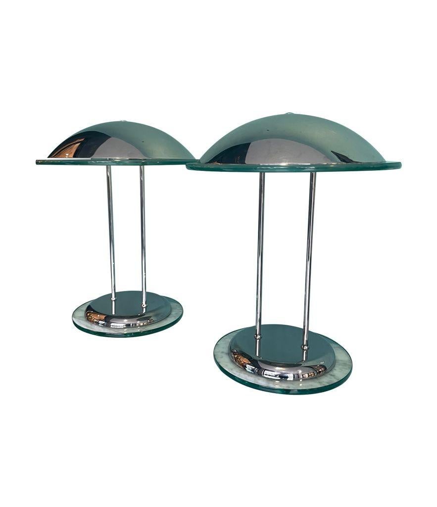 A pair of Art Deco style chrome and glass lamps by Dutch lighting company Herda. Each with chrome domed top with thick glass rim mounted on matching chrome and glass base. Re wired with new fittings and antique silver cord flex and switch and PAT
