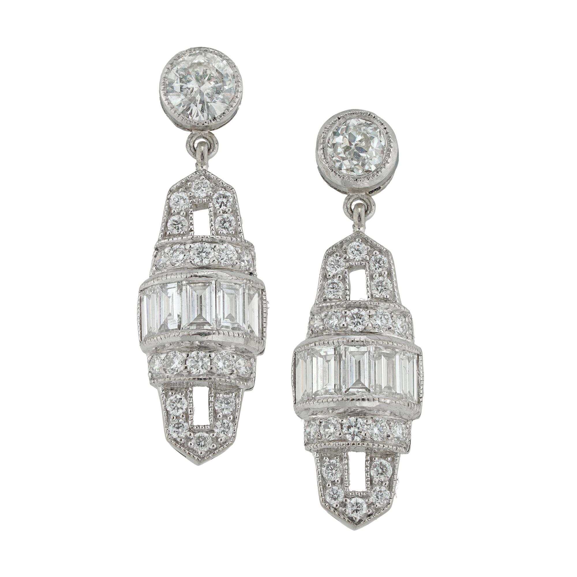 A pair of Art Deco style diamond drop earrings, each with a barrel-shaped openwork diamond plaque, centrally set with a line of baguette-cut diamonds within circular-cut pierced diamond borders, all suspended from a single diamond, diamonds