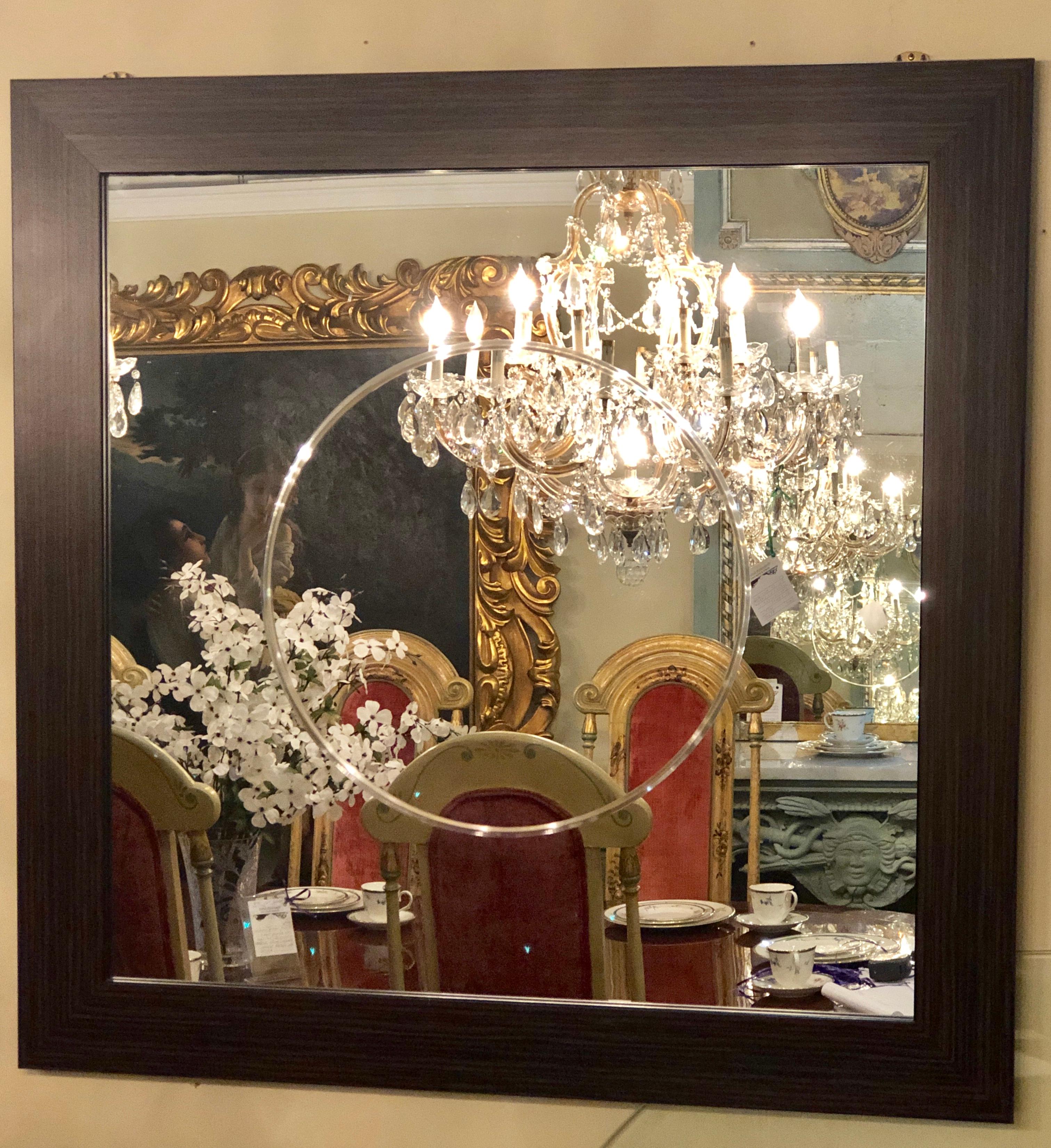 Pair of Art Deco style faux Macassar square console or wall mirrors. Purchase from a hotel in France we have one dozen of these squarish wall or console mirrors. Each having an etched circular in the center of the clear mirror set in a rosewood or