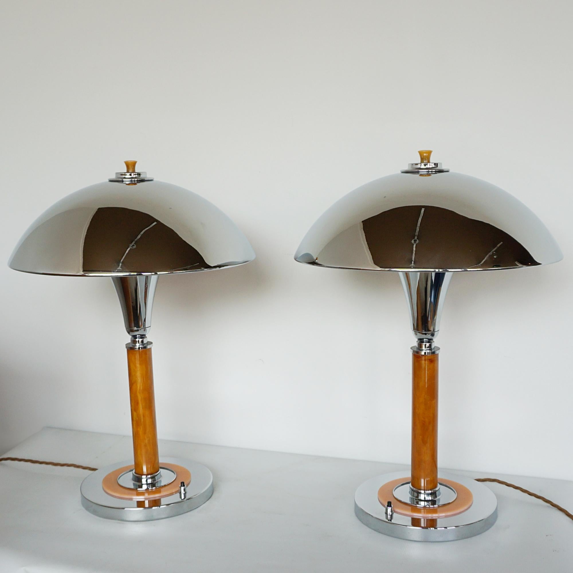 A pair of Art Deco style dome table lamps. Chromed shade and circular base with a bakelite orange stem. Bakelite finial to top.

Dimensions: H 50cm W 16cm, Diameter of shade: 35cm

Origin: English

Item Number: J327

All of our lighting is fully