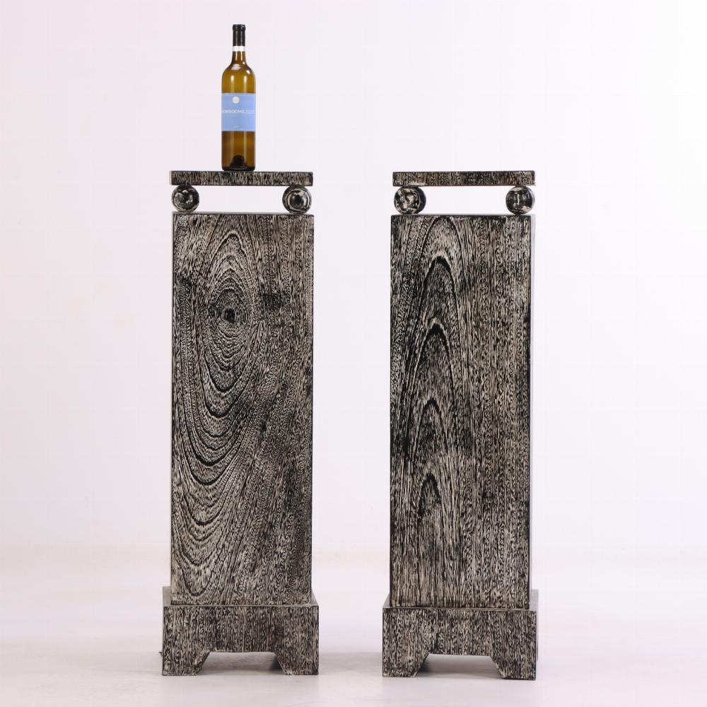 A pair of contemporary square pedestals crafted from dark moody cerused oak, evoking the geometric elegance and bold contrasts characteristic of Art Deco design. The deep, textured finish highlights the oak’s grain while lending a modern, sculptural