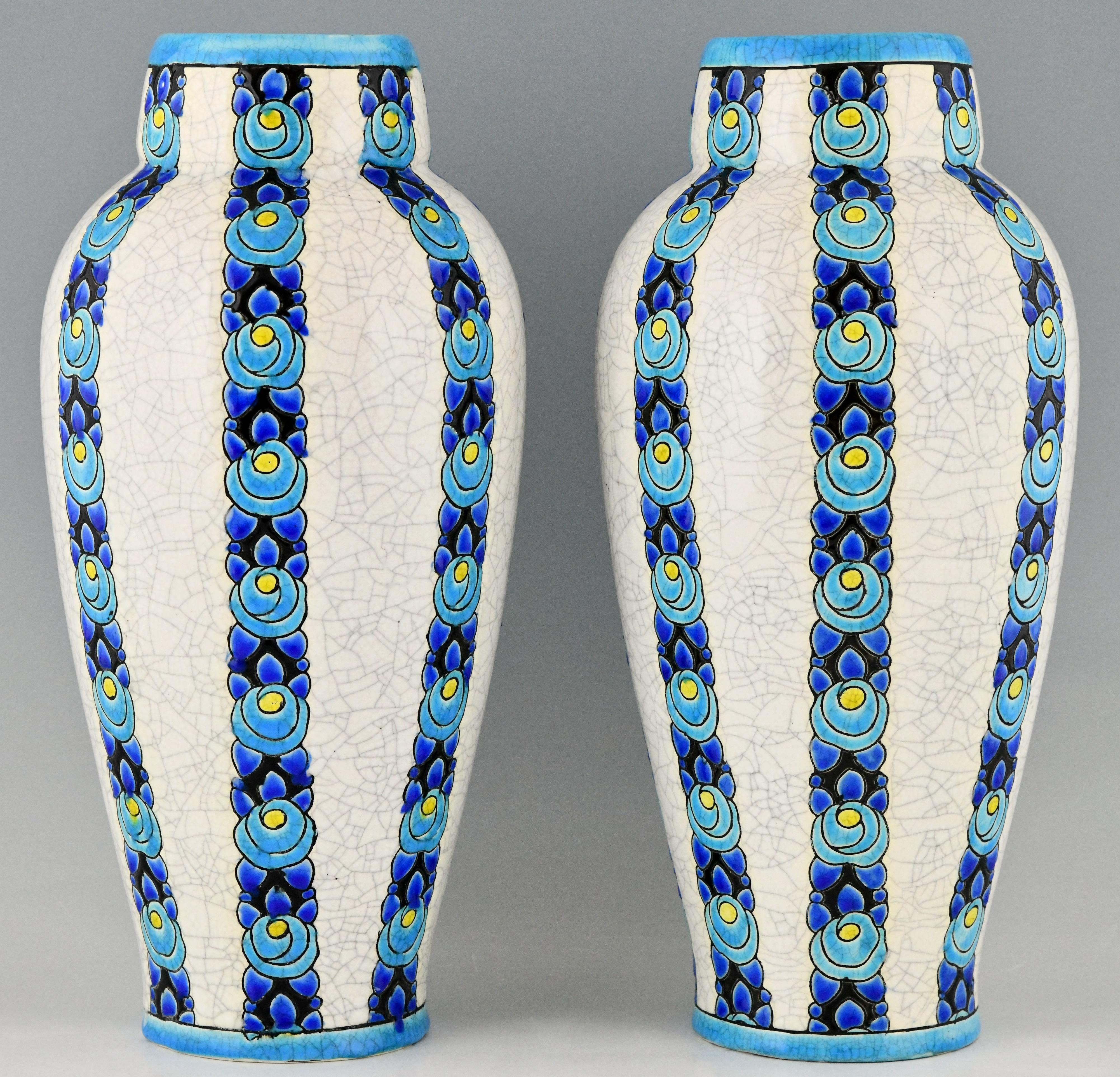 Tall pair of Art Deco turquoise, blue, yellow and white craquelé vases with flowers. Designed by Charles Catteau.
Executed by Boch Freres La Louviere, Belgium. 
Boch La Louvriere stamp. Ct for Catteau.
Numbered D704 for the
