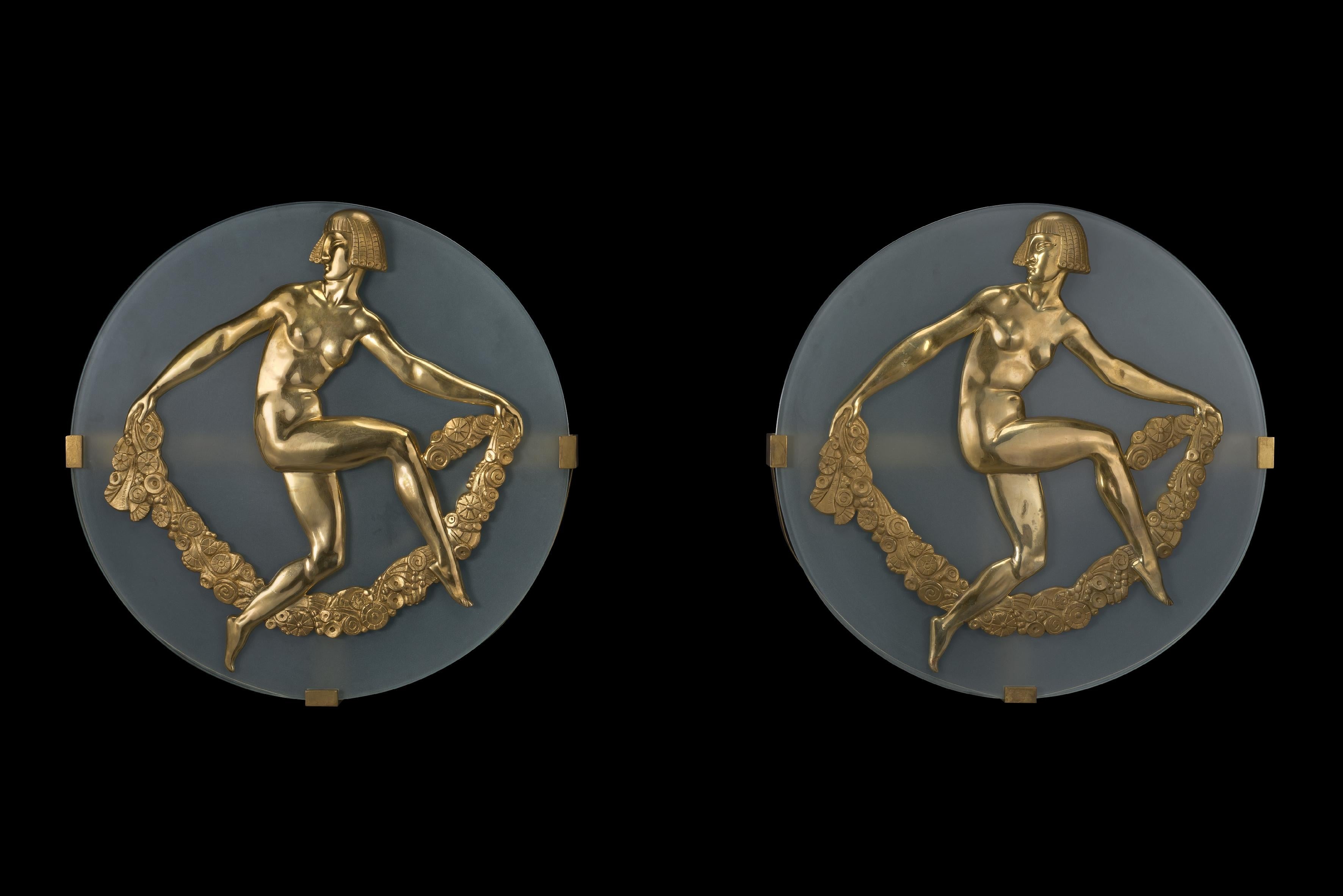 A fine pair Of Art Deco wall appliques by Albert Constant Jouanneault.

French, circa 1930.

Signed in the cast 'A. Jouanneault'.

Each circular frosted glass applique is mounted with a fine gilt bronze figure of a naked leaping dancer holding
