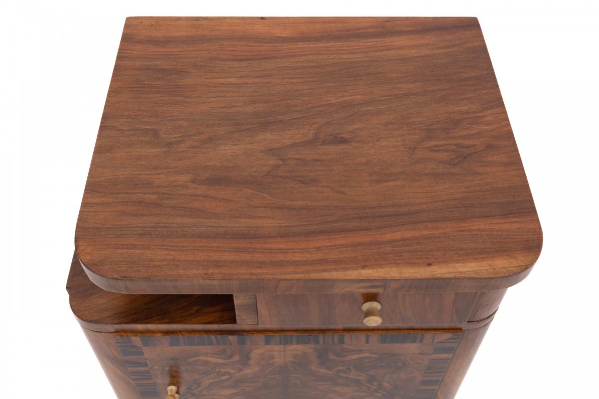 A pair of Art Deco walnut bedside tables. 1