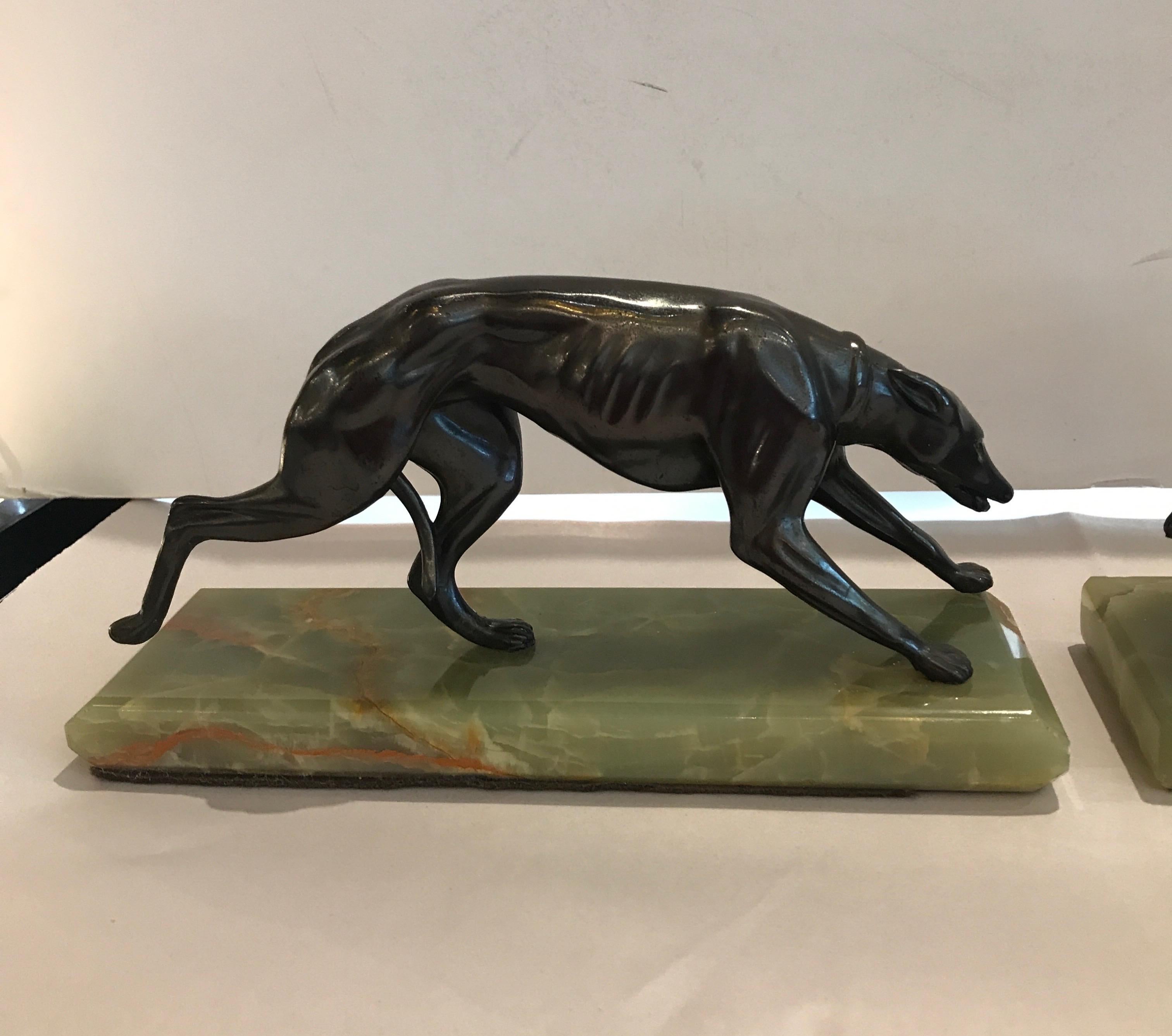 A pair of Deco bookends with agate bases. The bookends with a patinated metal whippet on each.