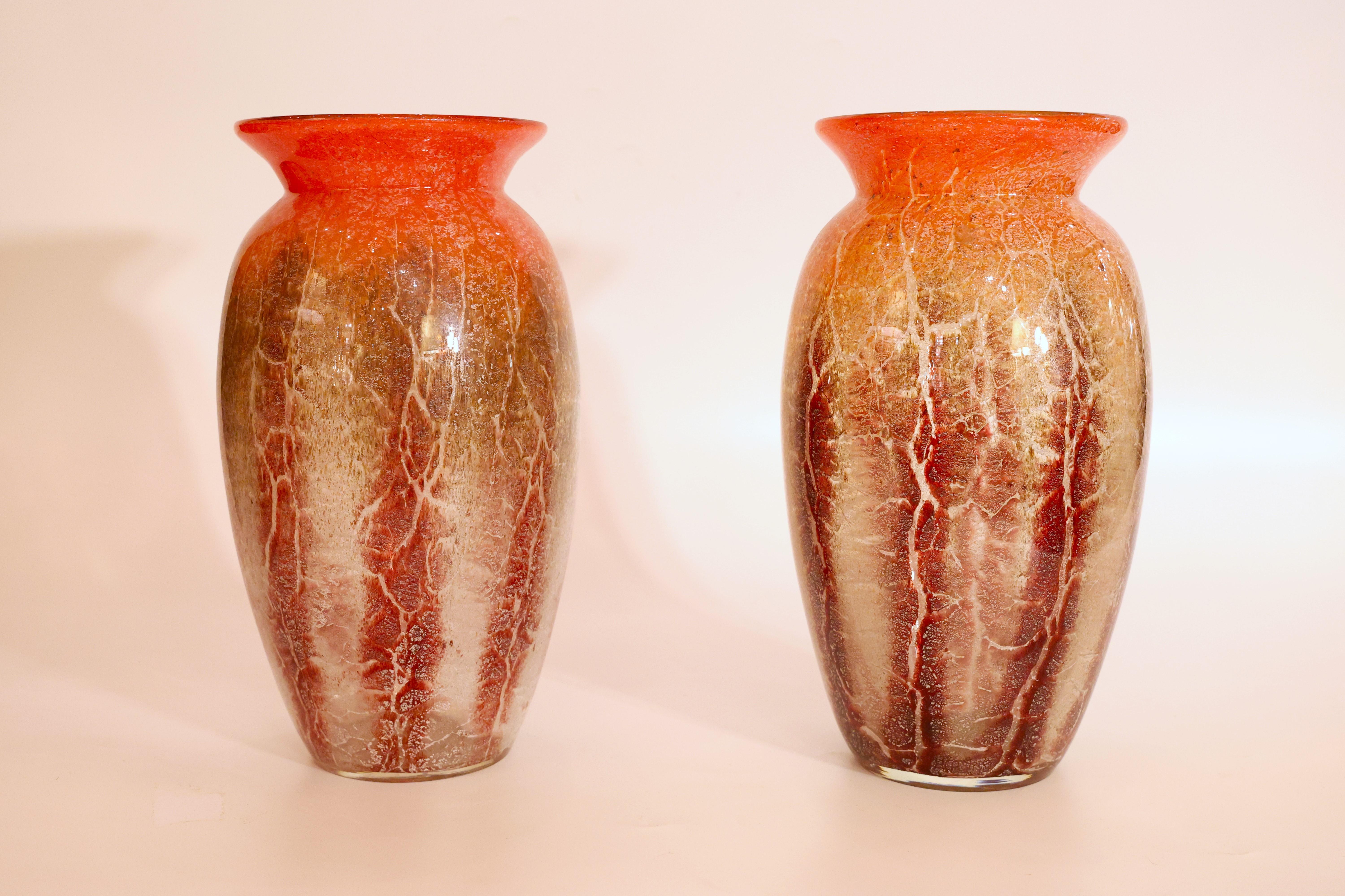 These WMF Ikora glass vases, designed by Karl Wiedmann around 1930, were produced by the Württembergische Metallwarenfabrik (WMF) glassworks. The Ikora line, introduced in the late 1920s, employed complex layering and chemical treatments to produce