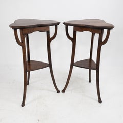 A pair of Art Nouveau beech stained side tables with clover leaf style tops