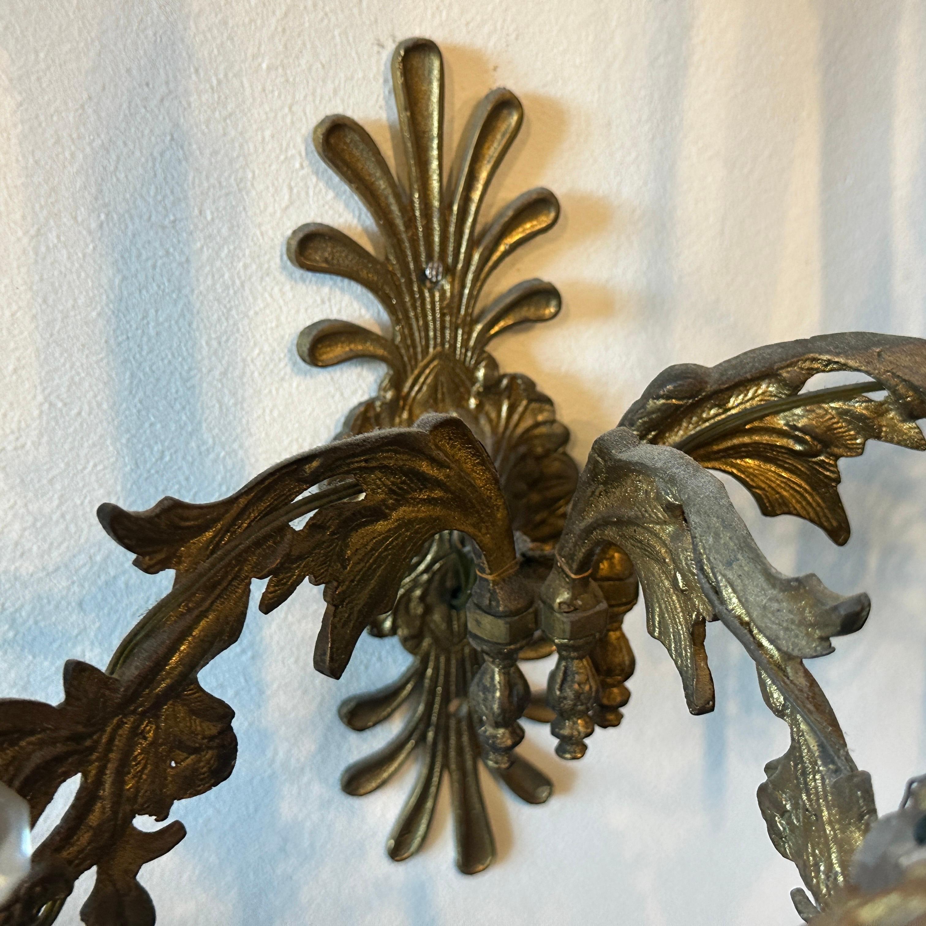 This pair of Art Nouveau Sicilian wall sconces features a graceful design crafted from gilded iron, embodying the organic and flowing aesthetic typical of the Art Nouveau movement. The gilding adds an elegant, aged patina that enhances their vintage