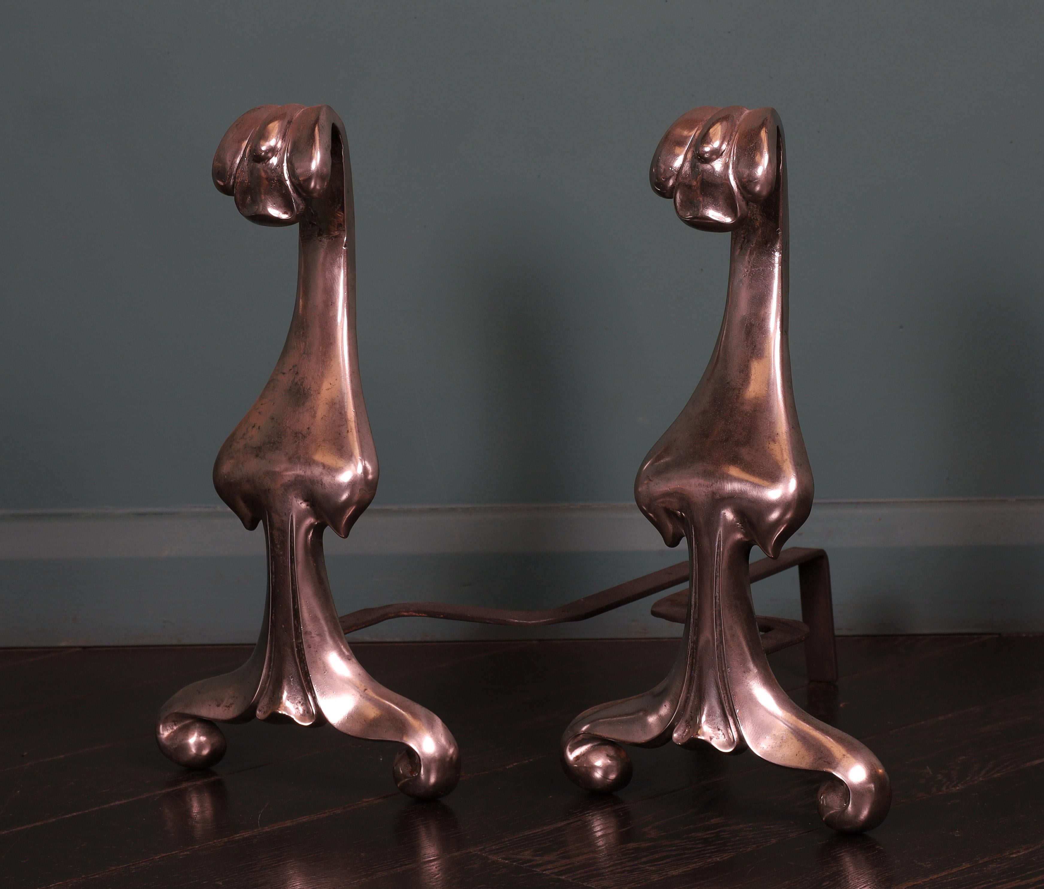 A pair of stylish Art Nouveau polished steel fire dogs with curved forward-facing petals uppermost, supported on scrolled feet. Restored.
Circa early twentieth century