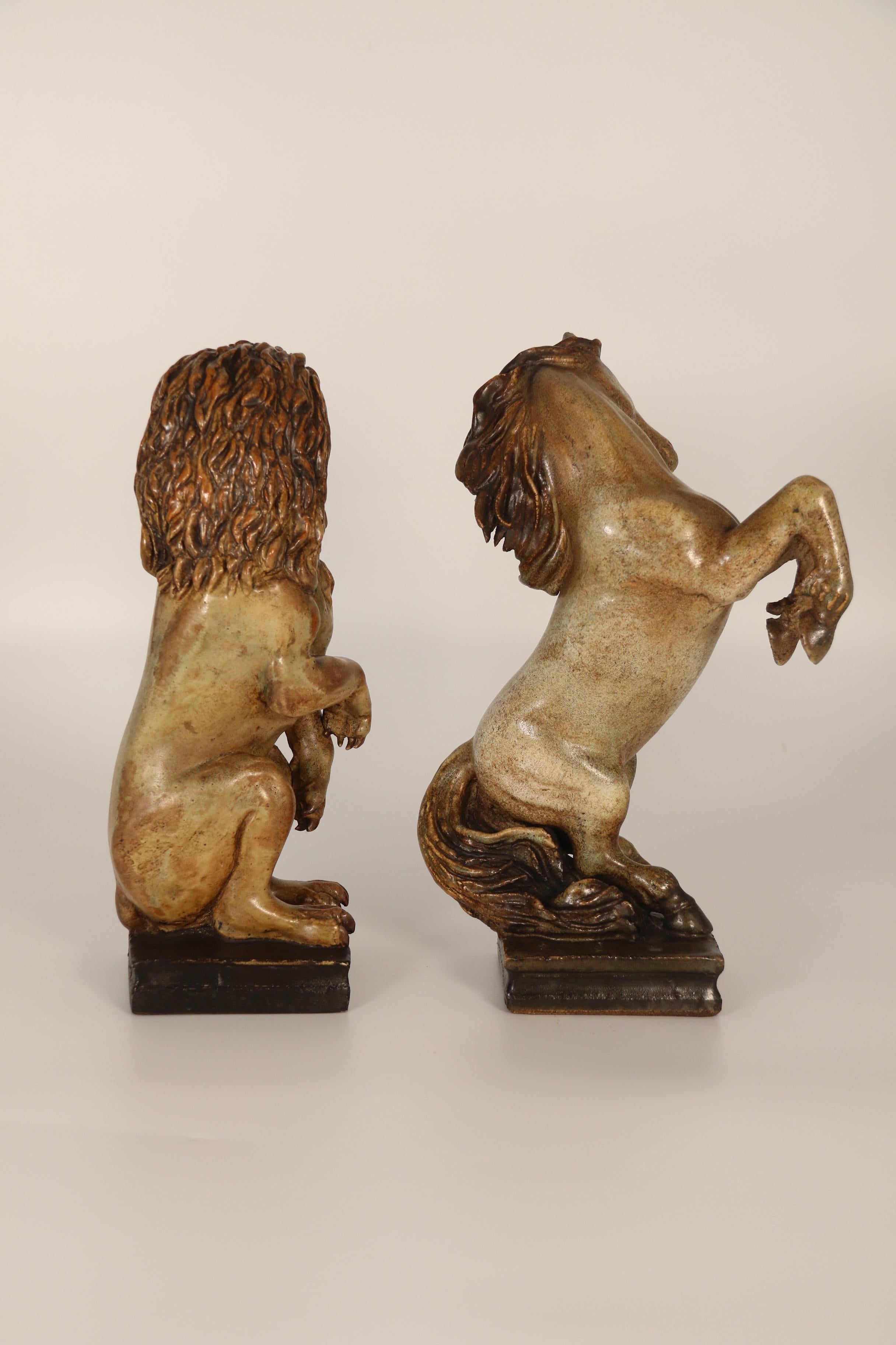 A pair of art pottery hand sculpted figures of a heraldic lion and unicorn. In Good Condition For Sale In Central England, GB