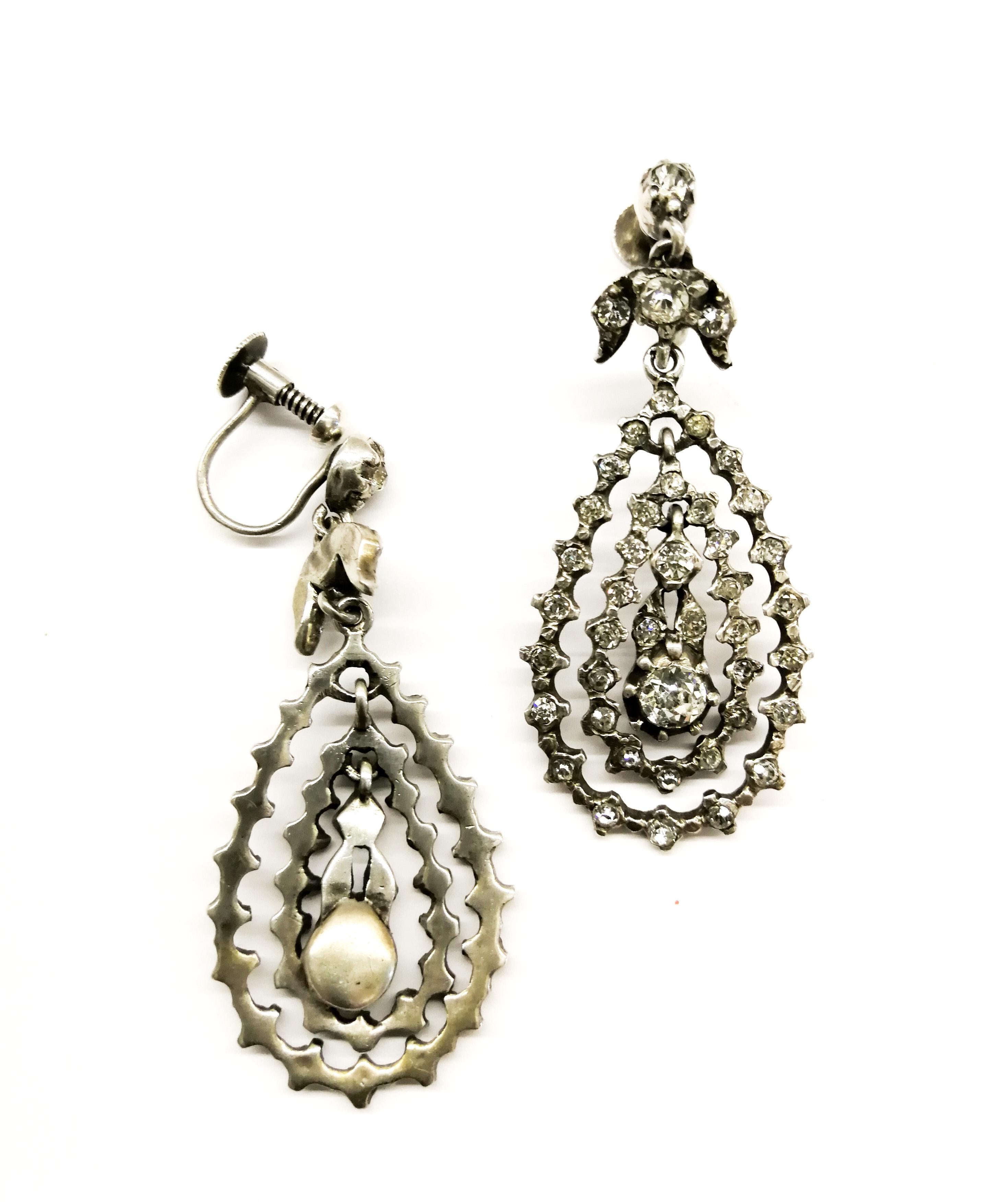 A very pretty pair of silver paste drop earrings, from the Edwardian era, with hand set stones in silver.  Each earring is made from three suspended parts, two 'hoops' and a small central pendant, catching the light and eye as they gently move and