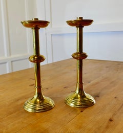 A Pair of Arts and Crafts Brass Candle Sticks