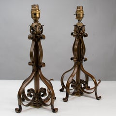 A pair of Arts and Crafts brass table lamps or post lamps