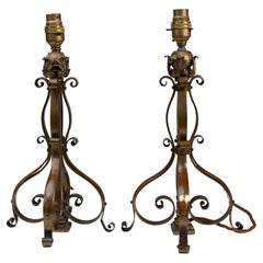 A pair of Arts and Crafts brass table lamps or post lamps